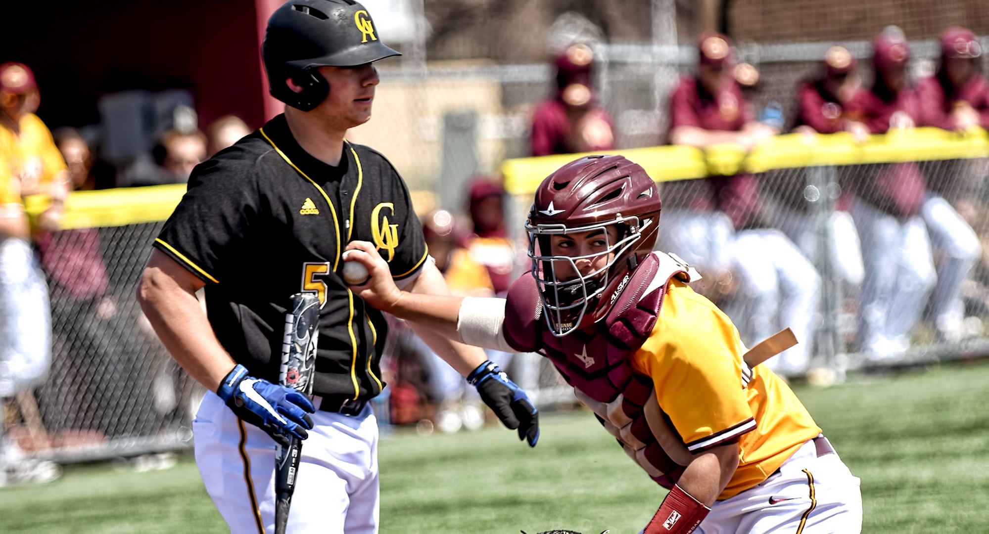 Junior catcher Alec Sames tags out a Gustavus hitter after a strikeout during the Cobbers' split with the Gusties.