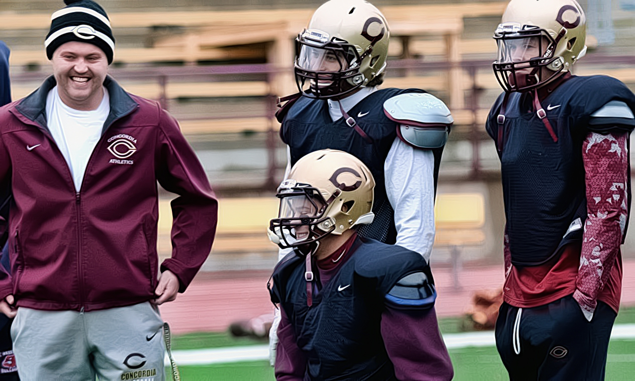 Concordia Director of Football Operation Sam Doody shares a laugh with the players during a recent practice.