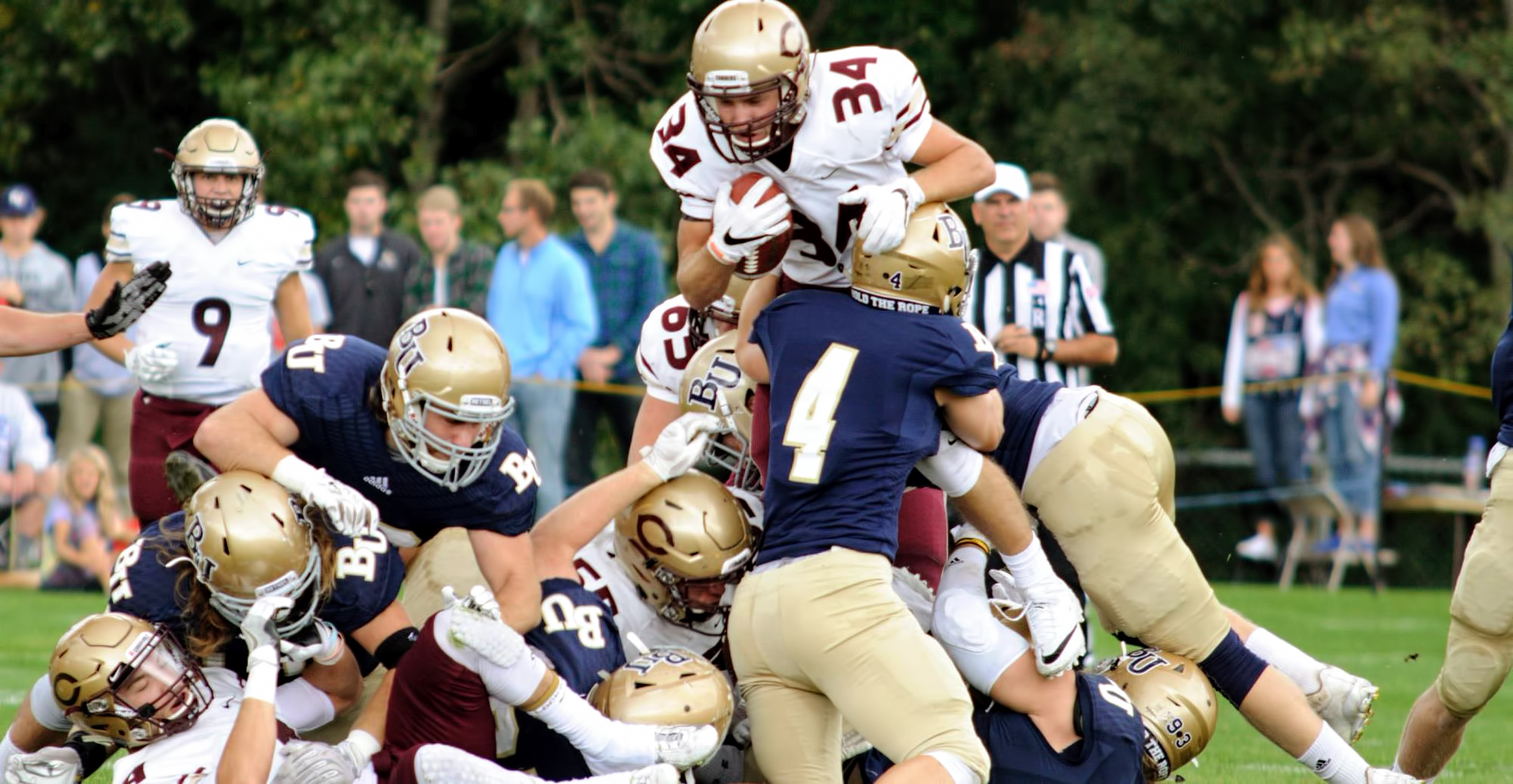 Sophomore Ryan Cihak goes up and over the pile during the Cobbers' 21-13 win at Bethel. He was one of seven CC backs to carry the ball in the MIAC-opening victory.  (Pic courtesy of Vince Arnold)