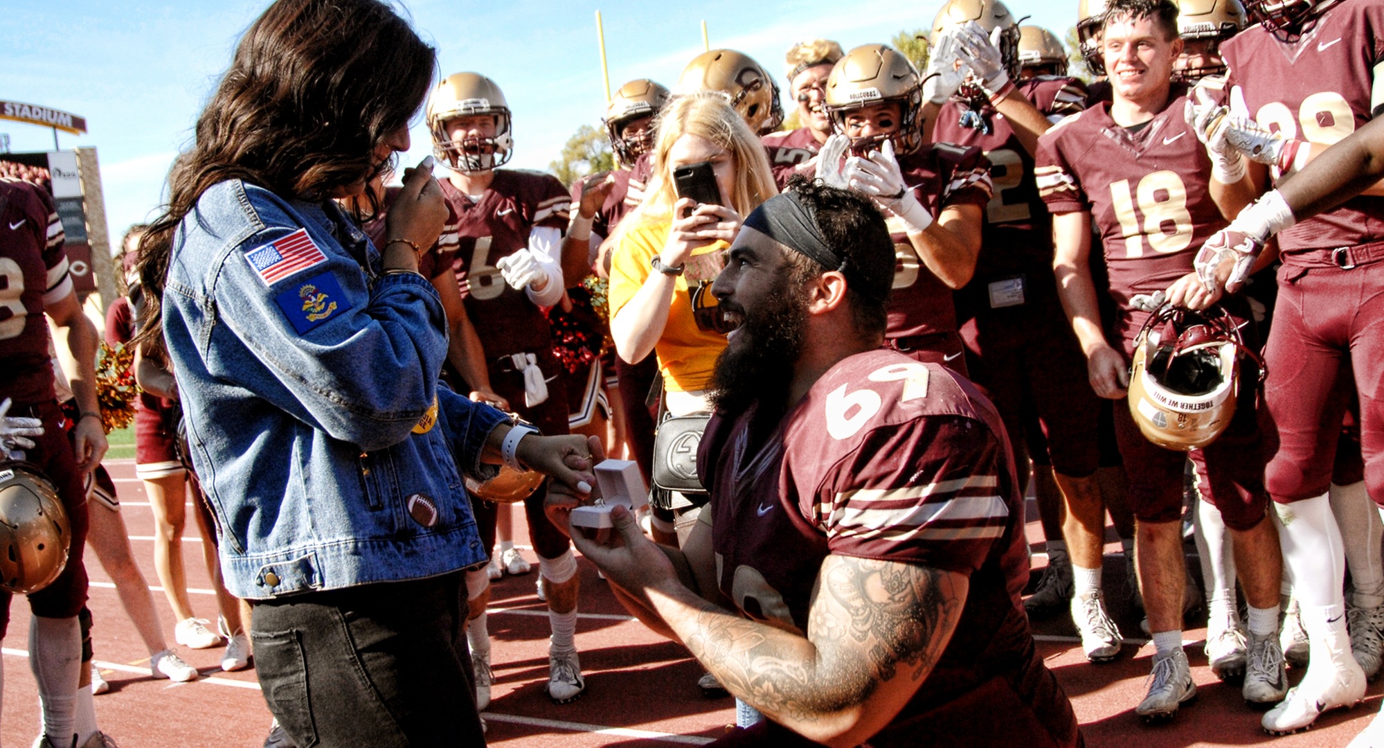 Senior Gunnar Kollman proposes to his girlfriend after the Cobbers' 55-0 win over Hamline.