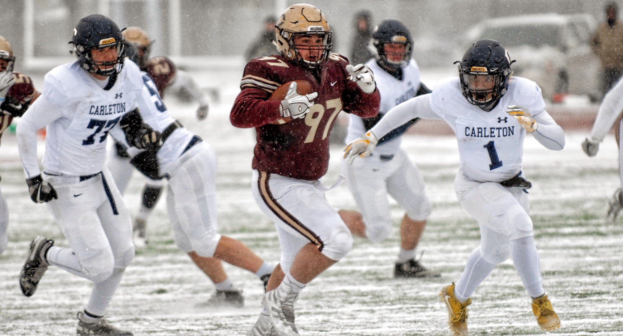 Senior Jesse Bucholz runs the ball after making an interception in the first quarter of the Cobbers' game with Carleton.