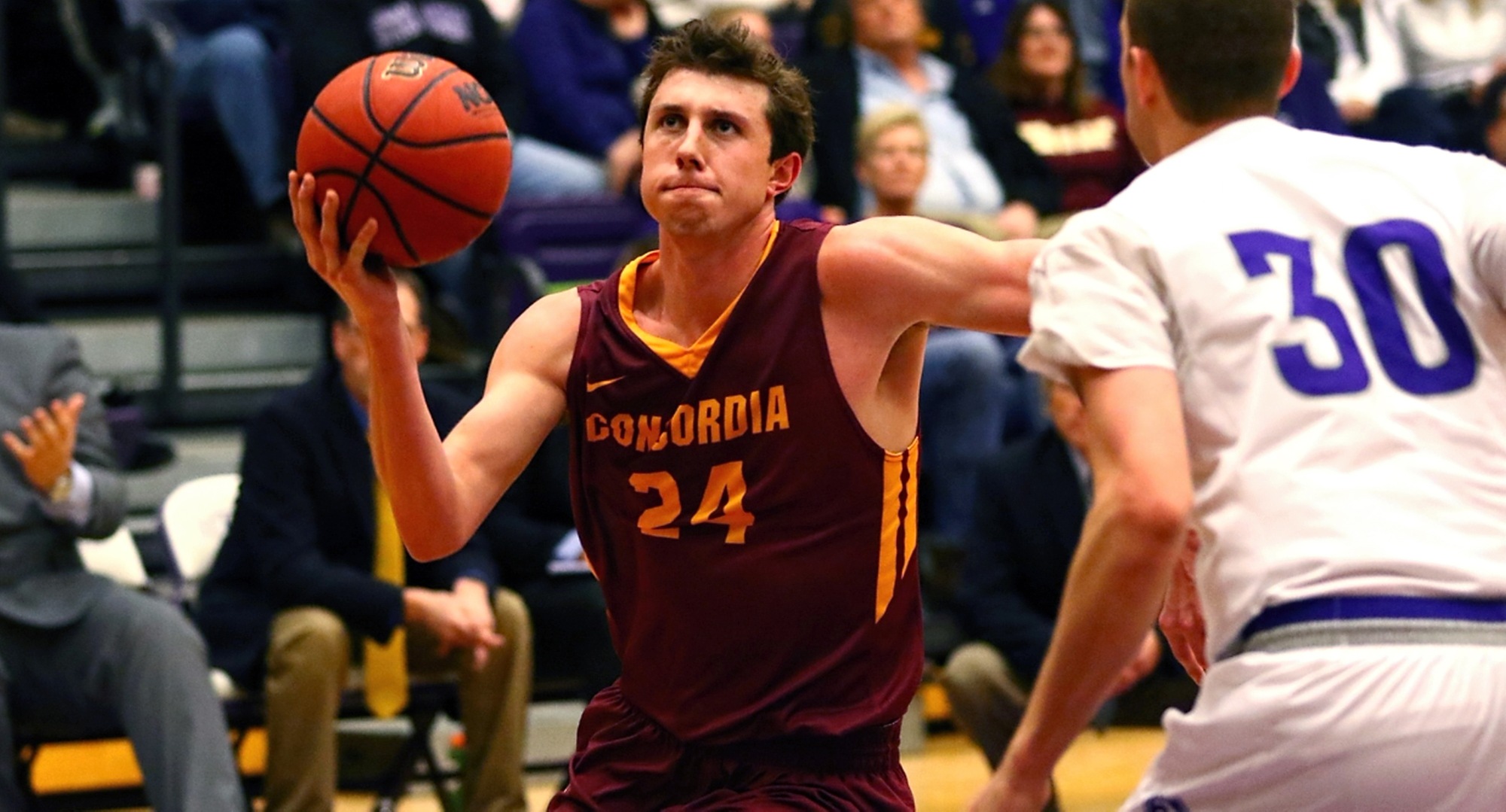 Senior Austin Nelson drives to the basket for two of his team-high 13 points in the Cobbers' game at St. Thomas (Photo courtesy of Ryan Coleman, d3photography.com)