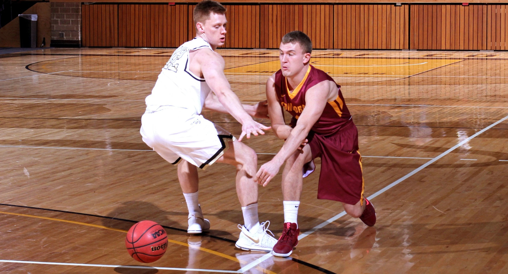 Junior Austin Rund makes an entry pass to the post during the Cobbers' game at St. Olaf. (Photo courtesy of St. Olaf Sports Information Department)