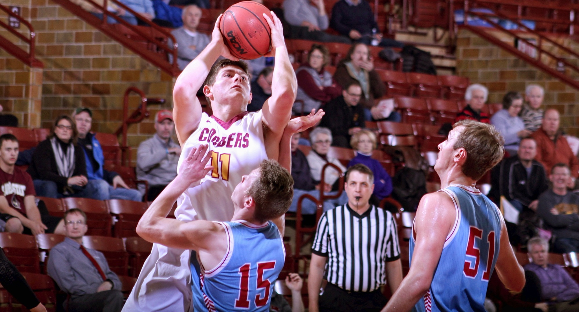 Senior Dylan Alderman drives to the basket during the first half of the Cobbers' game with St. John's.