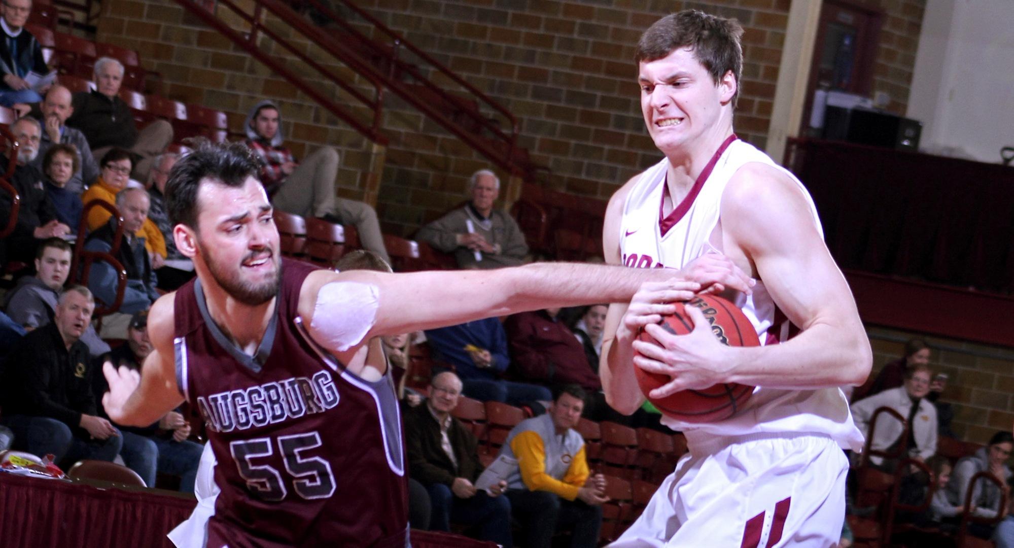 Junior Kevin Wolfe grabs a rebound away from an Augsburg player during the Cobbers' win over Auggies. Wolfe finished with seven points.