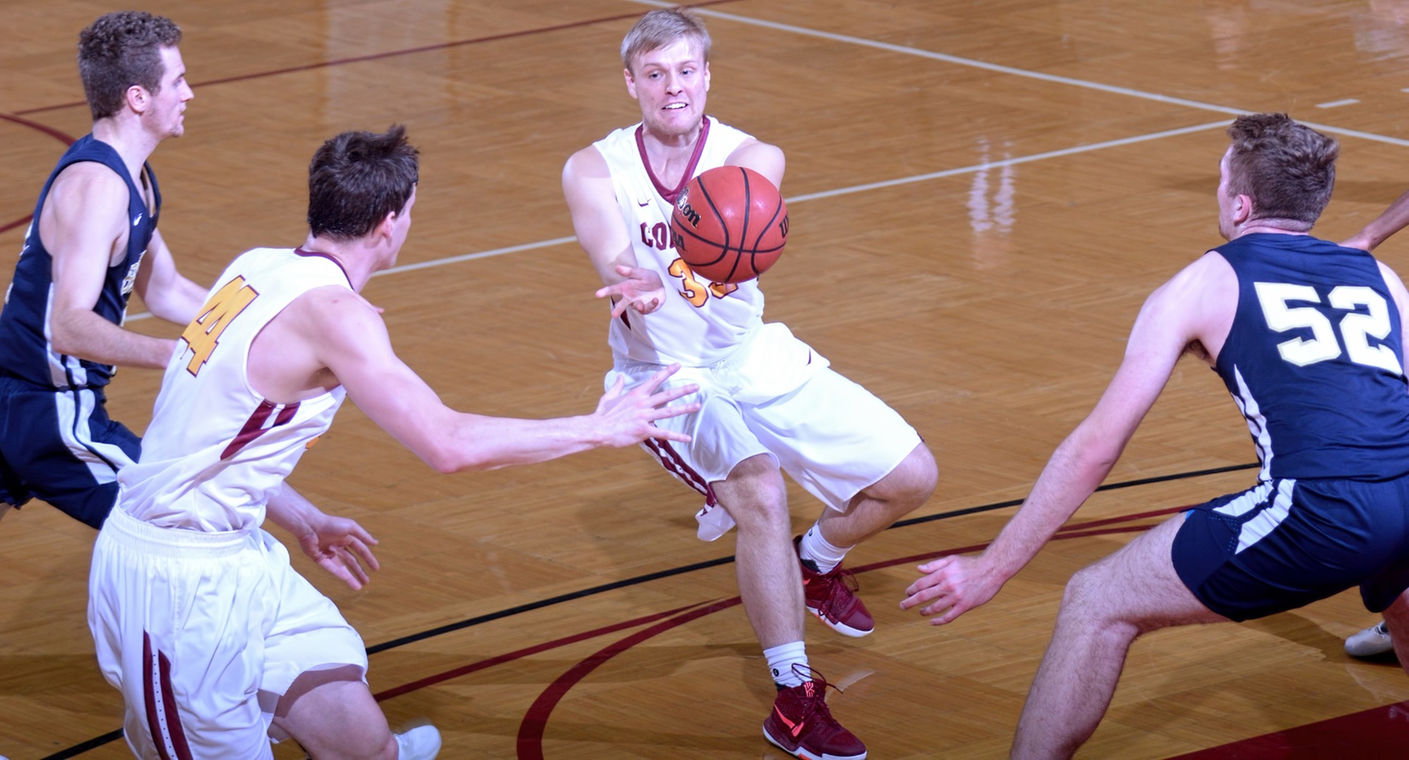 Freshman Seth Friesz dishes the ball to Kevin Wolfe for two of his career-high 25 points in the first half of the Cobbers' game with Bethel.