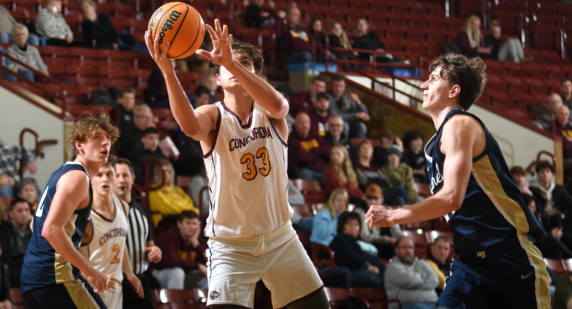 Jacob Cook goes to the basket for two of his 14 points in the Cobbers' game with Bethel. He also had 11 rebounds to post his first double-double.