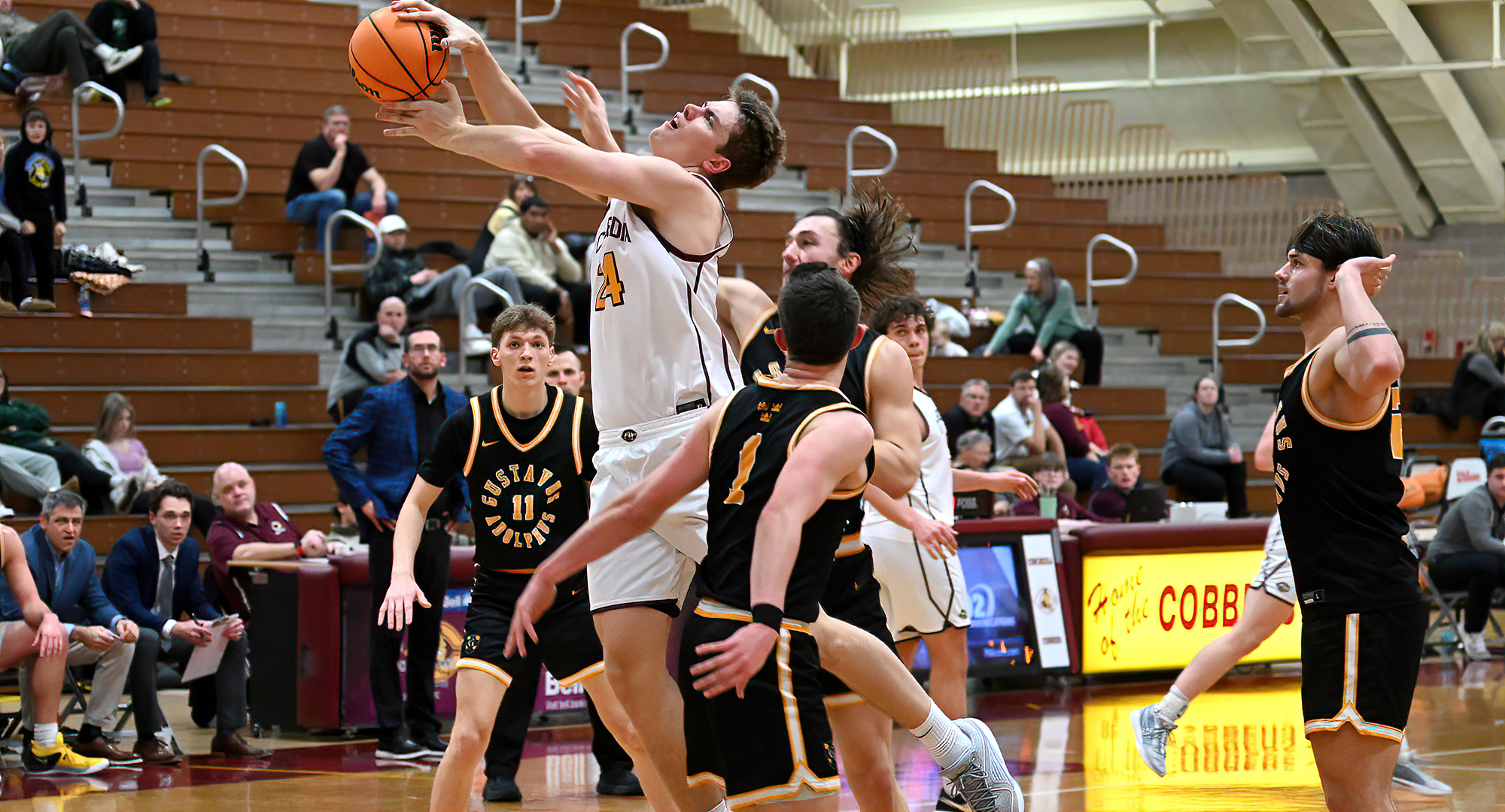 Jackson Loge goes to the basket and gets fouled in the first half of the Cobbers' game with Gustavus.