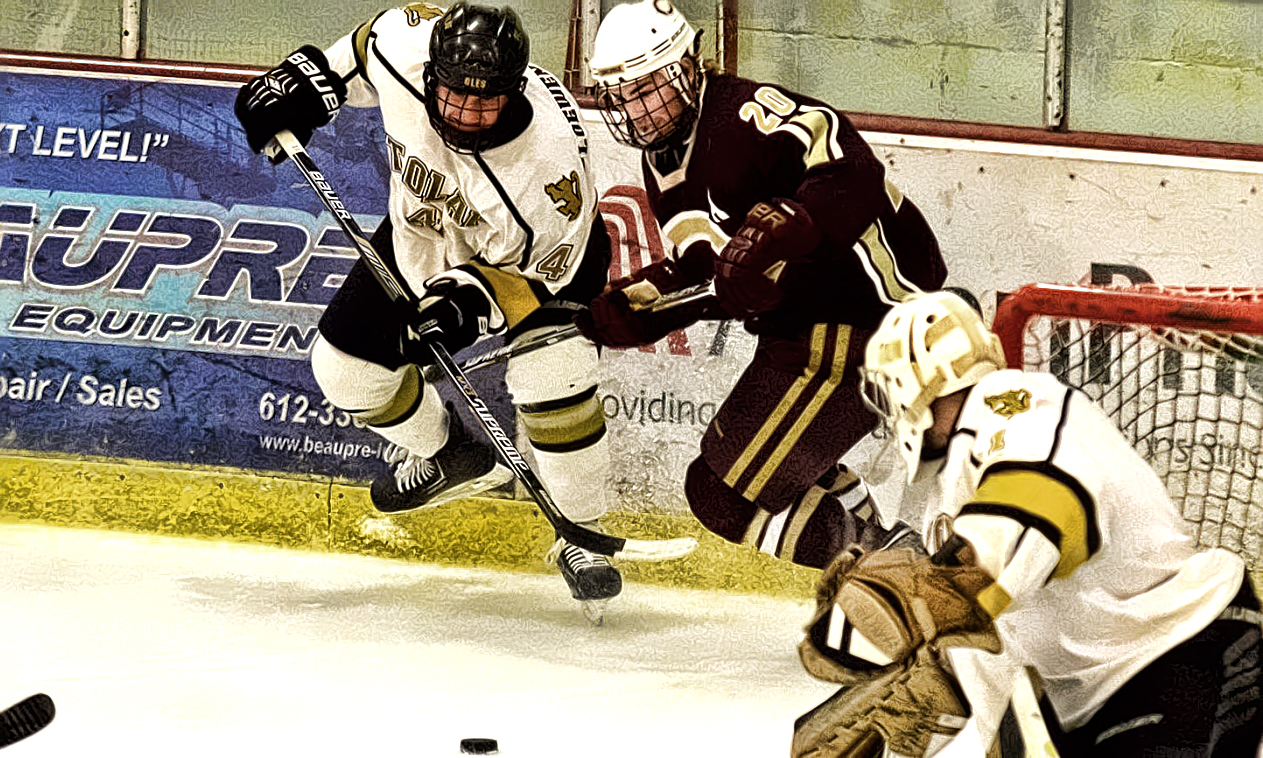 Junior Jeremy Johnson fights for the puck behind the St. Olaf goal in the Cobbers' loss on Sunday. Johnson assisted on Concordia's second goal. (Photo courtesy of MIAC Office)