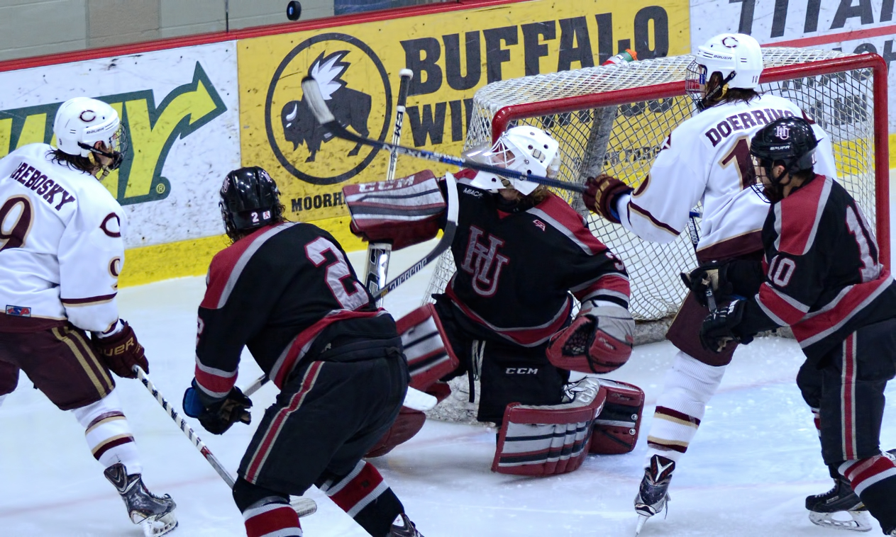 Concordia forwards Jon Grebosky and Zach Doerring converge on the puck at the Hamline goal during the Cobbers' MIAC quarterfinal game with the Pipers.