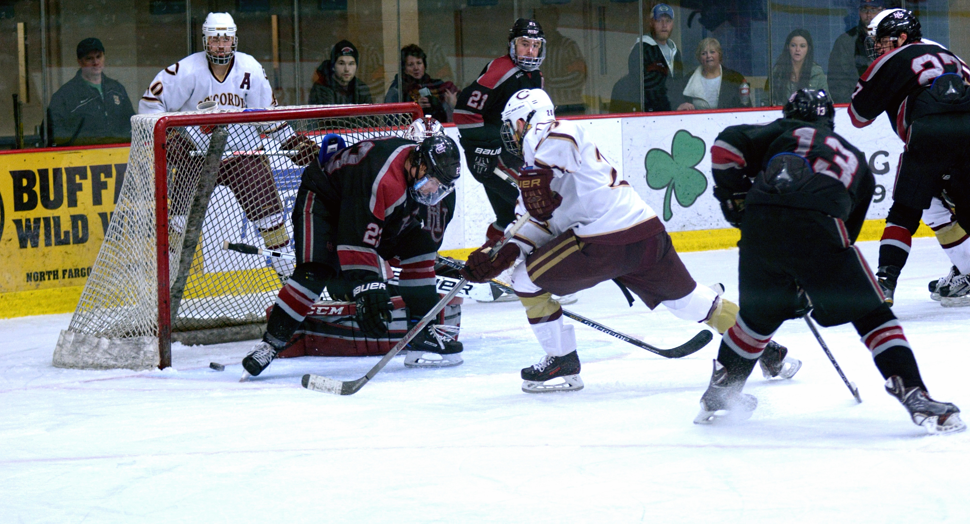 Garrett Hendrickson (behind net) has his centering pass trickle off a skate and hit the post in the final minute of the Cobbers' series finale with Hamline.