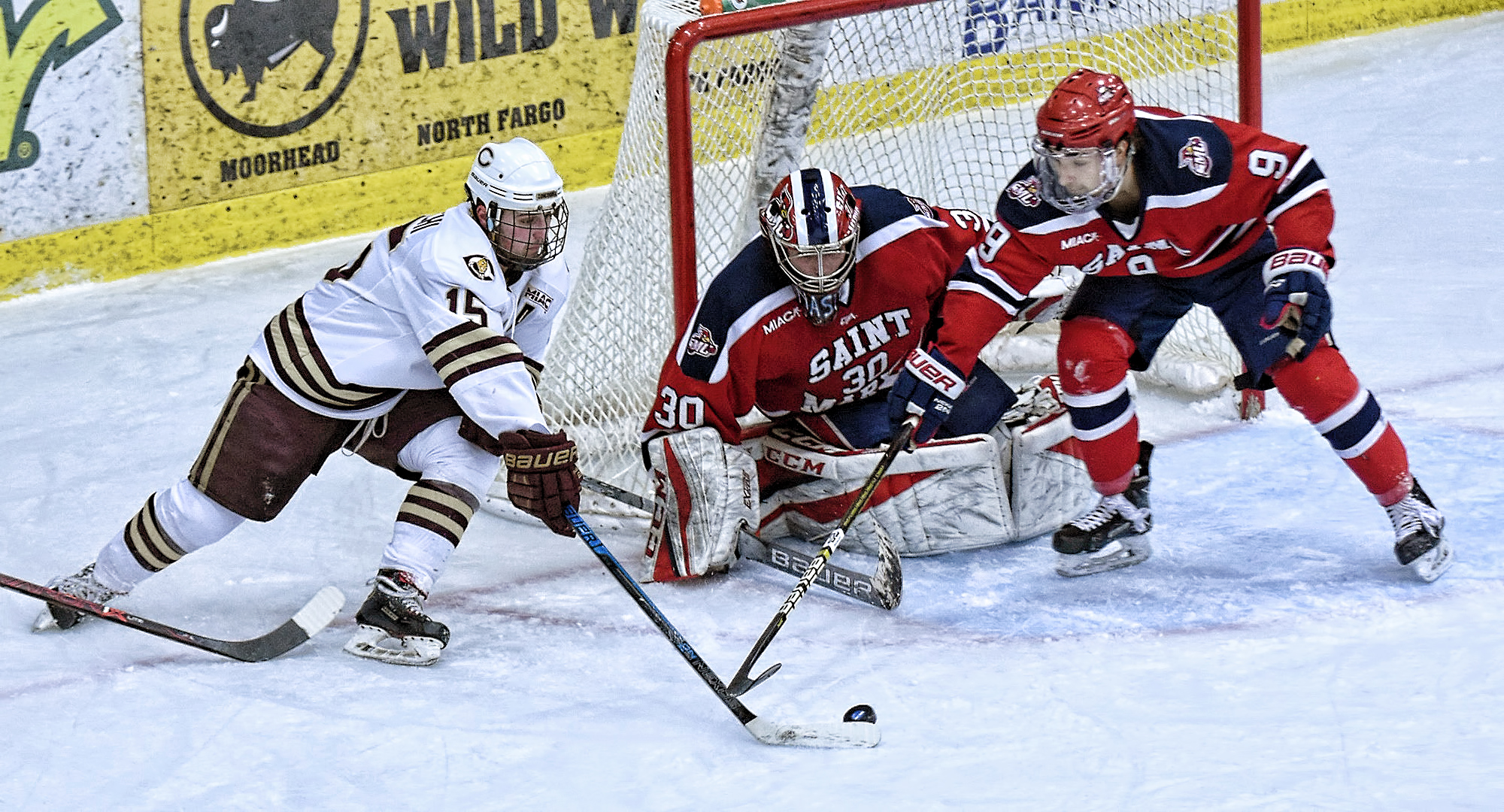 Mario Bianchi works the puck around the St. Mary's goal to set up the Cobbers' second goal in their MIAC quarterfinal game against the Cardinals.