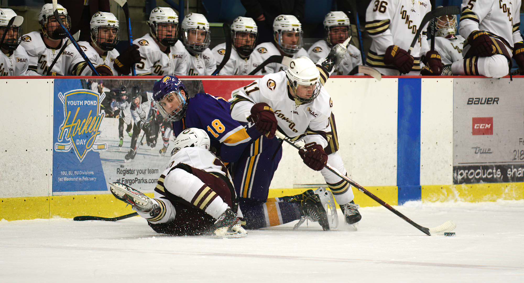 Jacen Bracko goes over a pair of bodies to gain control of the puck in the Cobbers' game with #10 UW-Stevens Pt. Bracko assisted on CC's first goal.