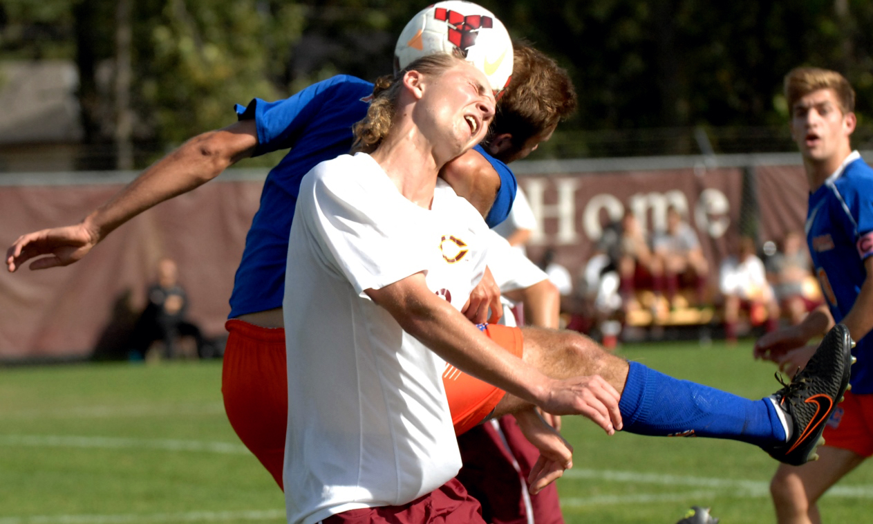 Cobber freshman Christian Erickson wins the header in the team's game with Macalester.