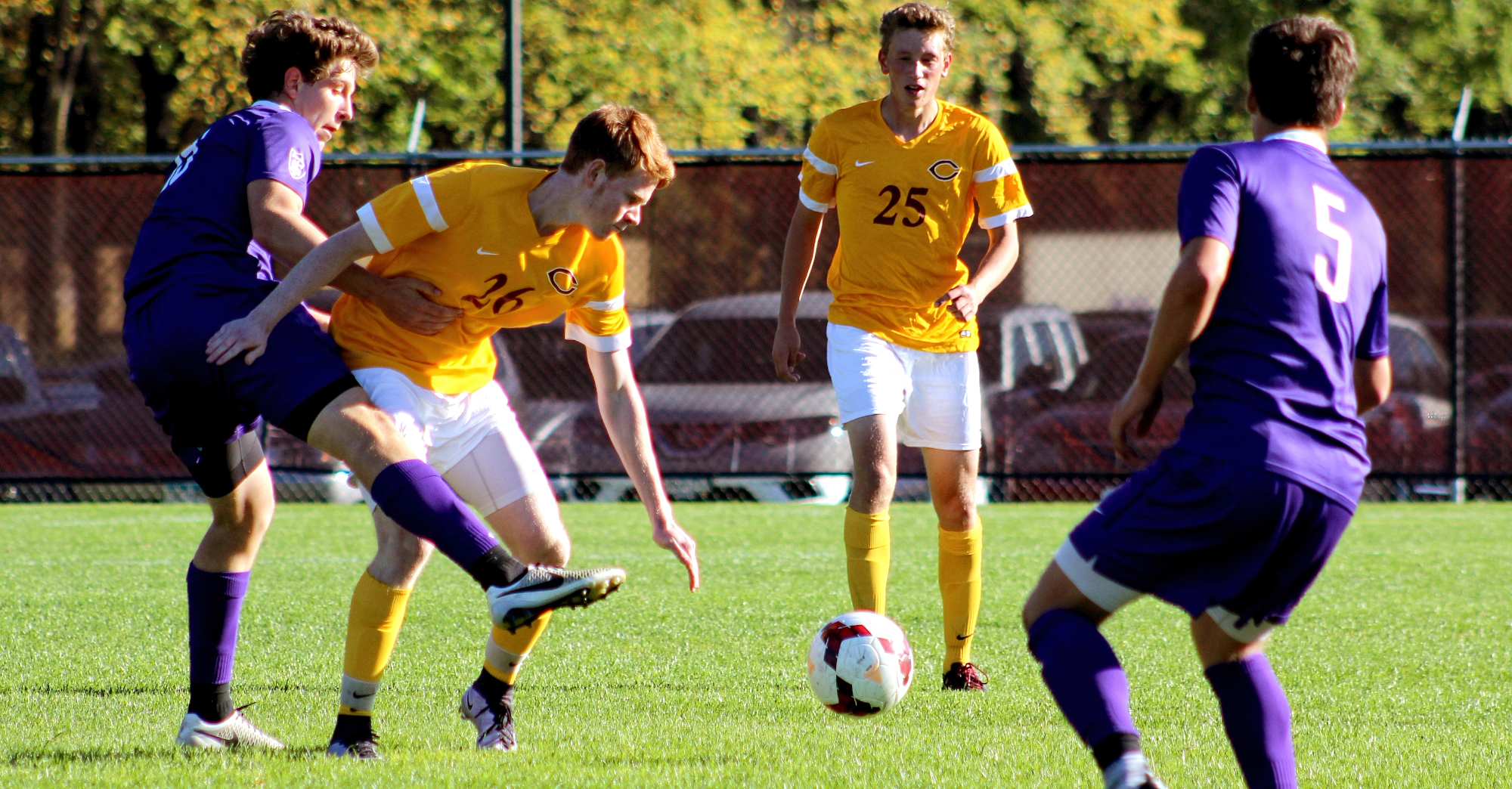Freshman Nick MacArthur battles for the ball as fellow freshman Henry Schaefer looks on during the Cobbers' game with St. Thomas.