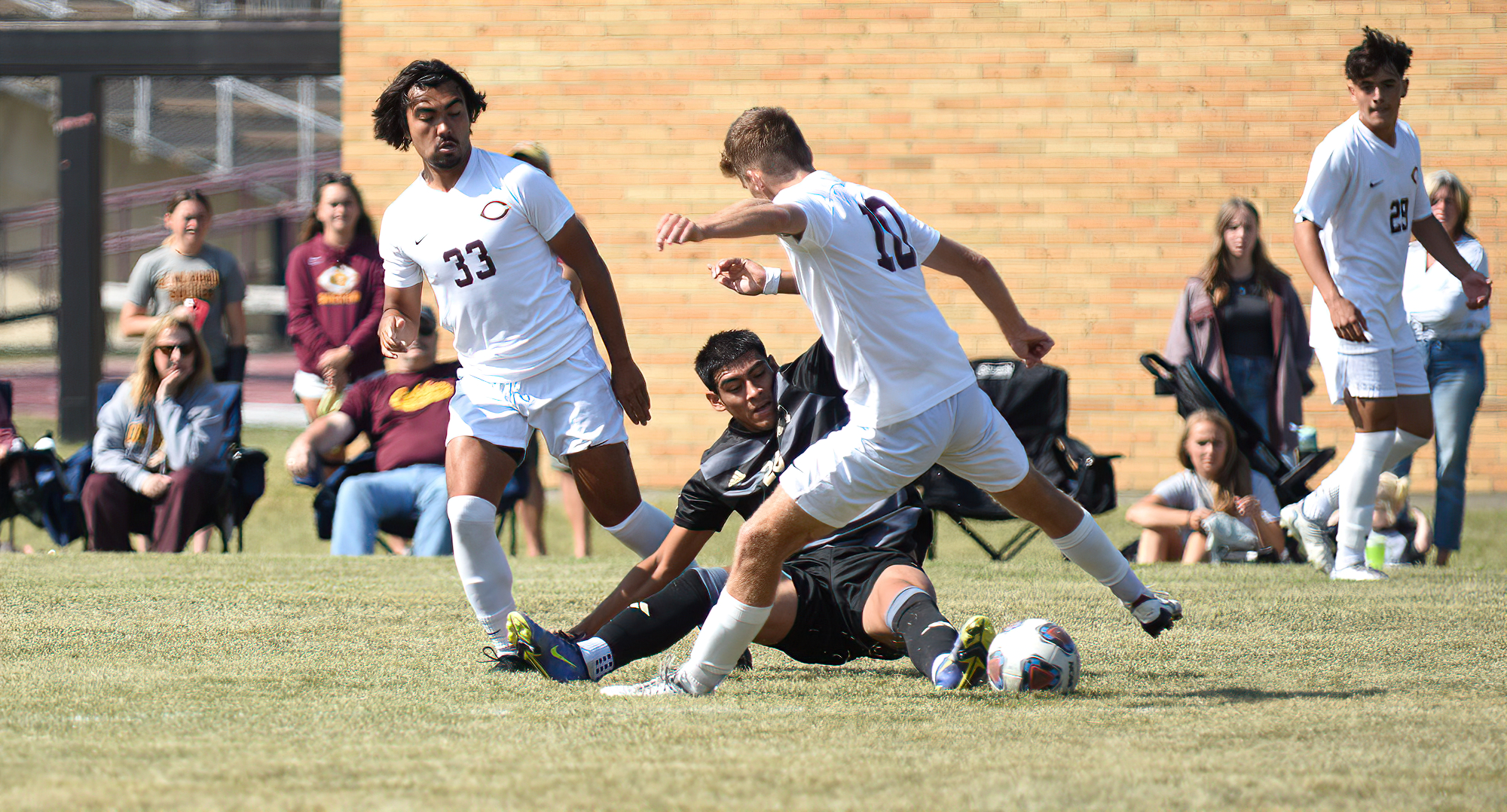 Kai Black (#33 - left) and Owen Gallo (far right) scored the Cobbers' two goals in their 2-1 win at St. Scholastica in the MIAC opener.