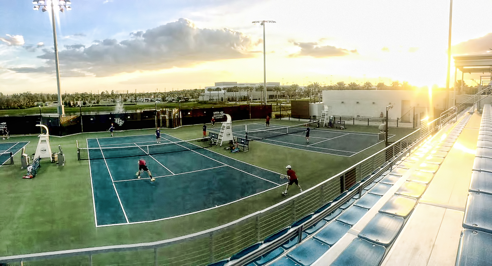 The Cobber doubles teams play under the setting sun at the USTA Tennis Center in Orlando.