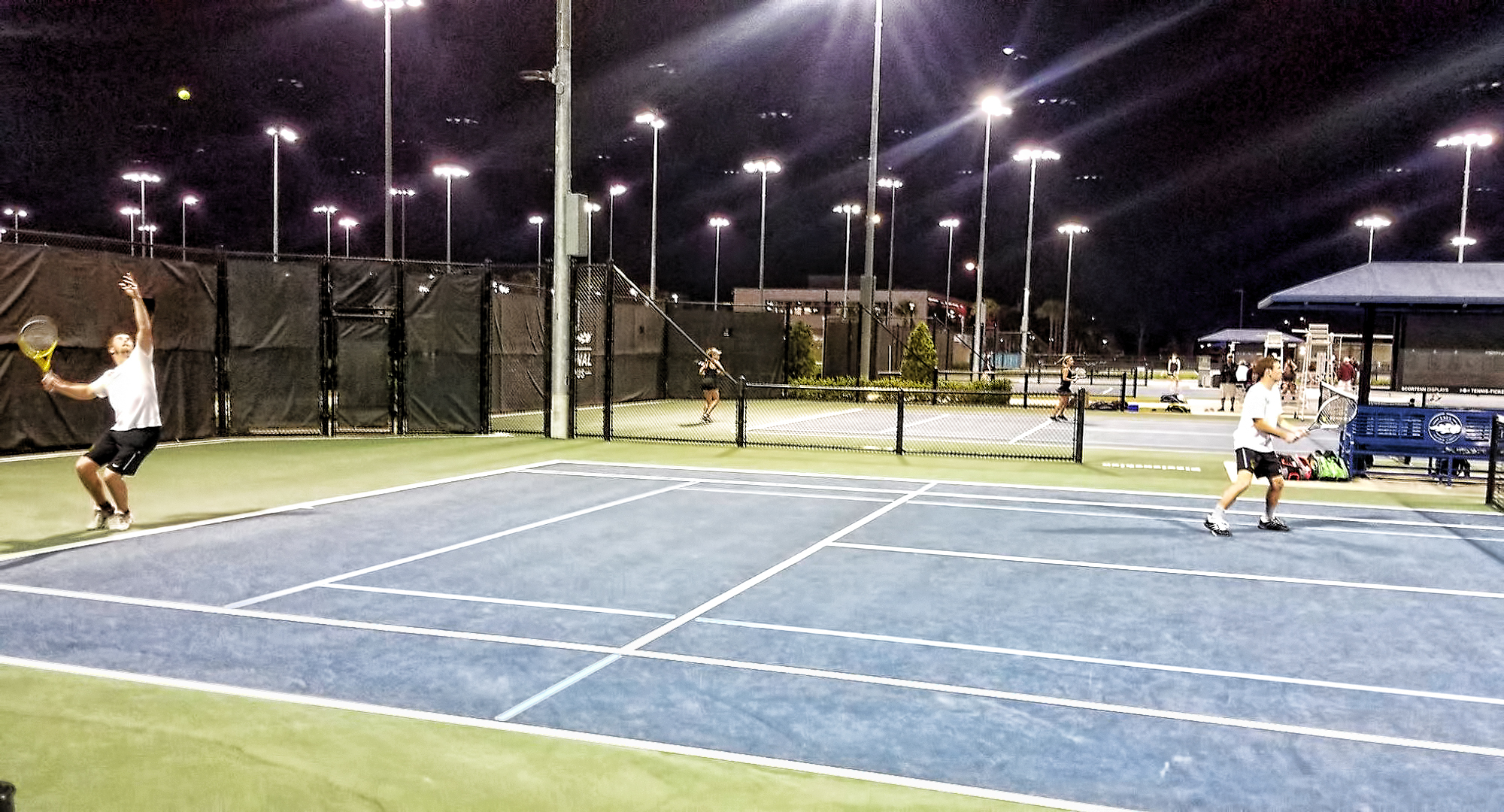The No.2 doubles team of David Schneck (L) and Erik Porter play under the lights during the Cobbers' finla match in Florida.