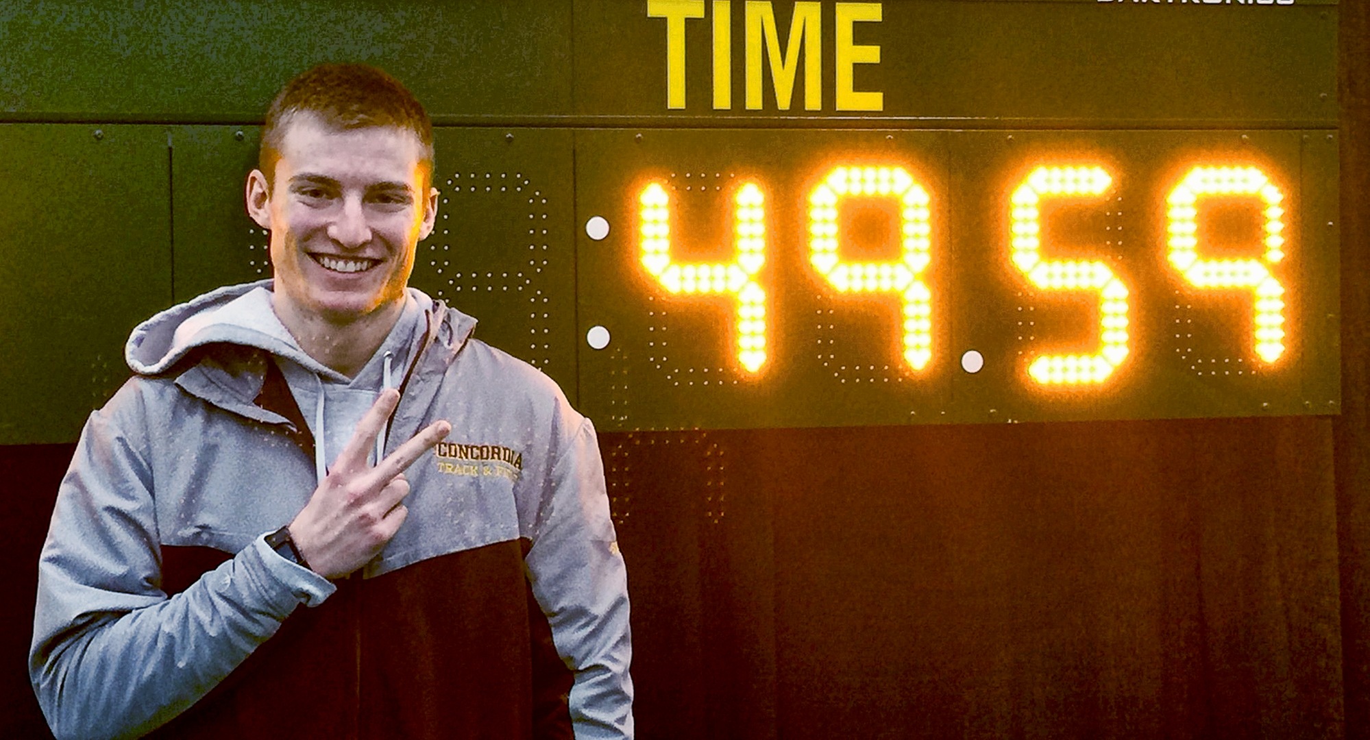 Sophomore David Supinski stands next to his school record time in the 400 meters after breaking his second school record mark over the weekend.