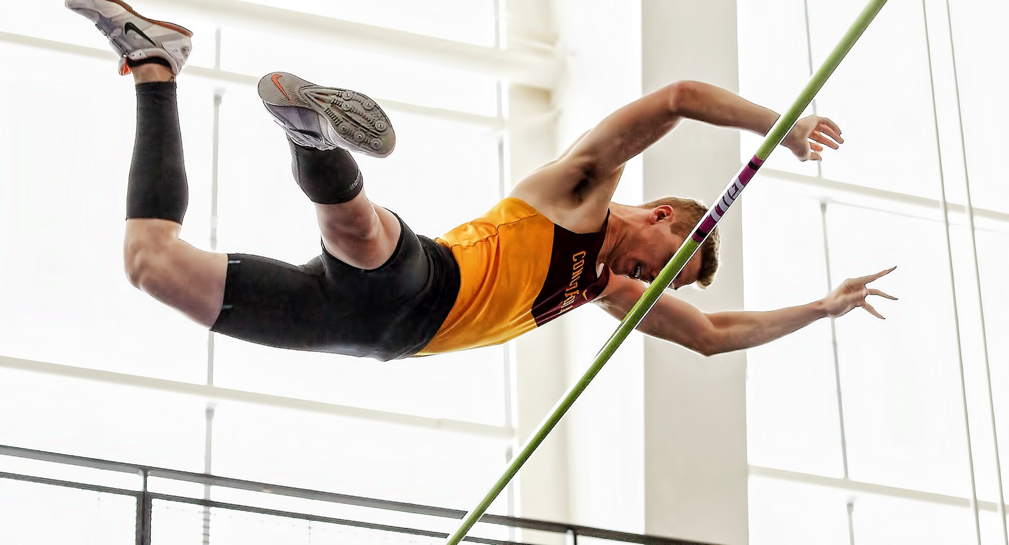 Senior Sam Haley sails over the bar in the pole vault at a career-best height of 14-06 on his way to a second-place finish at the MIAC Indoor Meet. (Photo courtesy of Nathan Lodermeier)