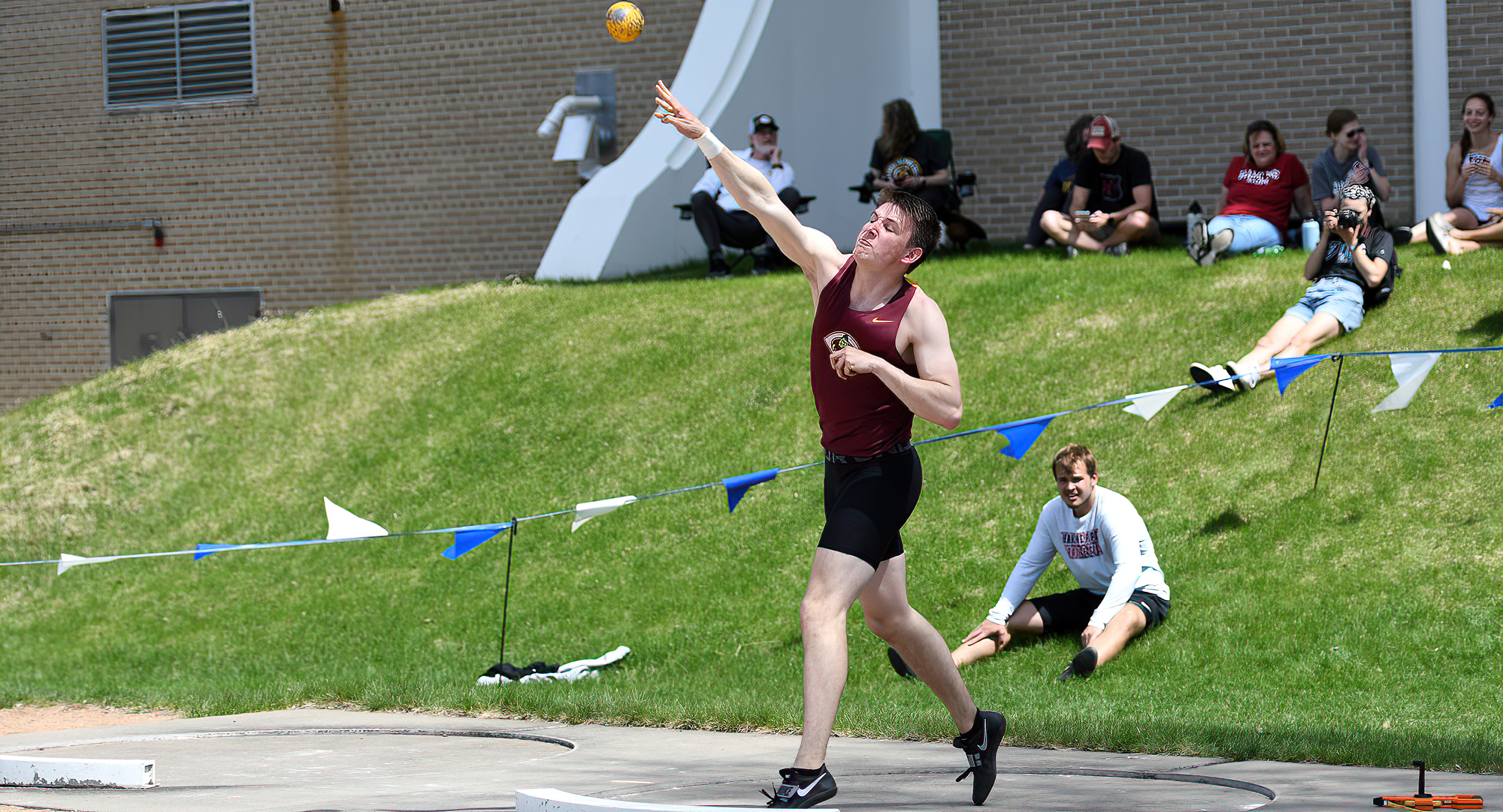 Wade Rhonemus lets go of the shot put during the first day of the MIAC decathlon competition. (Photo courtesy of the Carleton Sports Info Dept.)