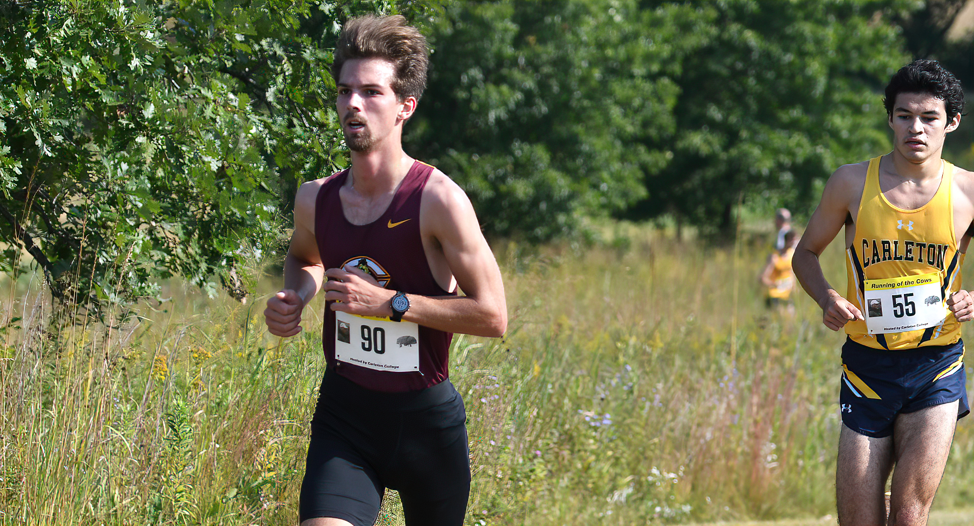Senior Tanner Olson pulls away from a Carleton runner at the Running of the Cows Meet. (Photo courtesy of Carleton SID)