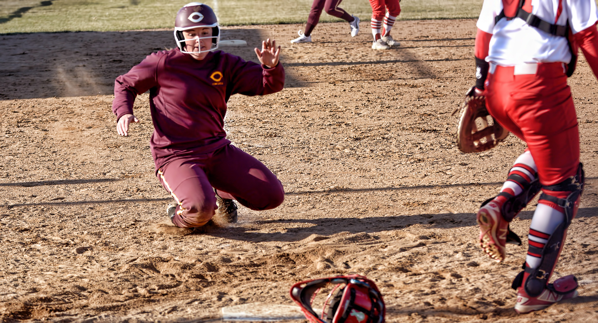 Junior Brooke Swarthout gets ready to slide into home as she scores the first run in the second game of the Cobbers' DH with MSU Moorhead.