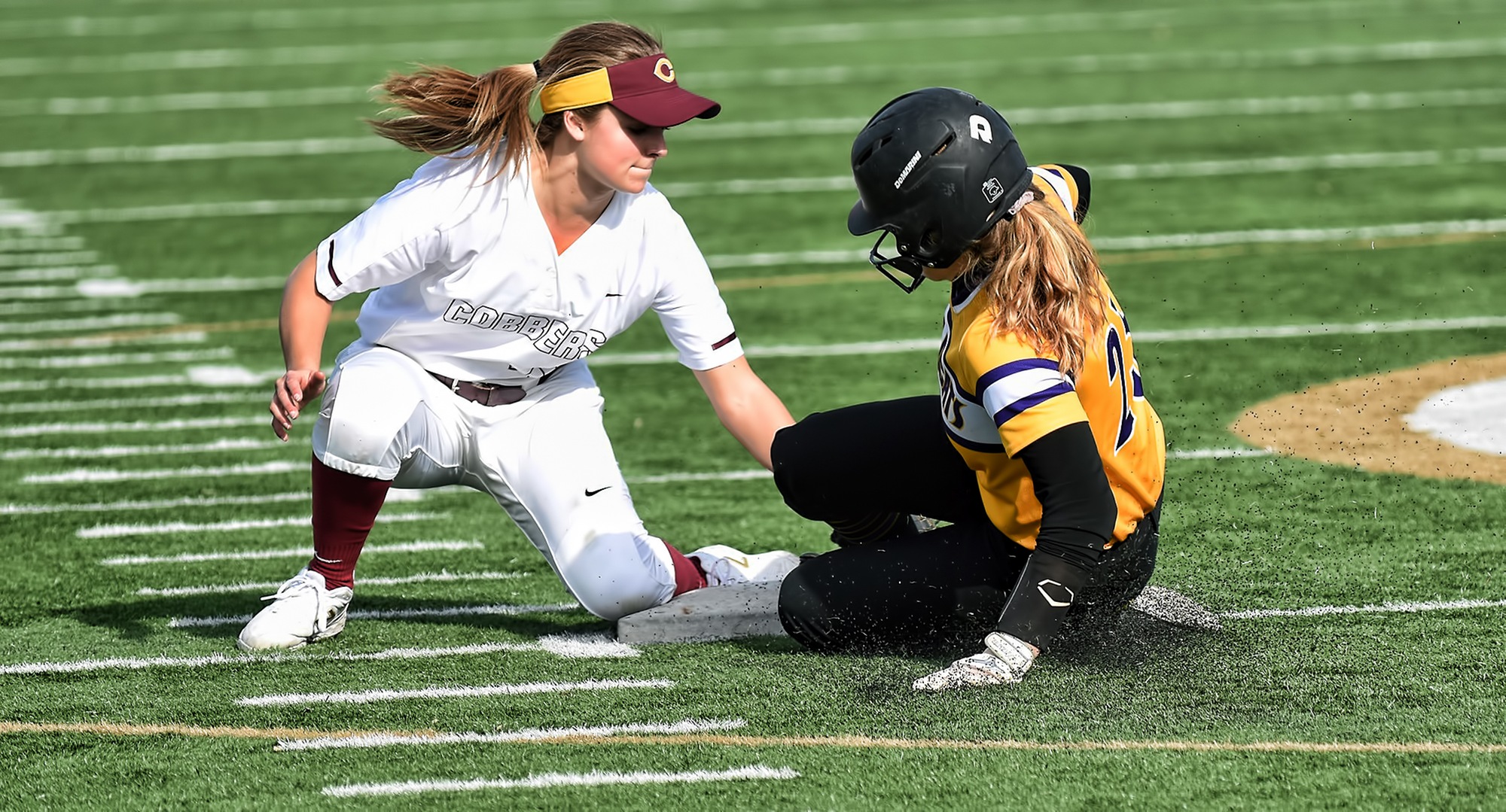 Freshman shortstop Maria Pake plants the tag on a would-be St. Catherine base stealer during the second game of the Cobbers' DH with the Wildcats.