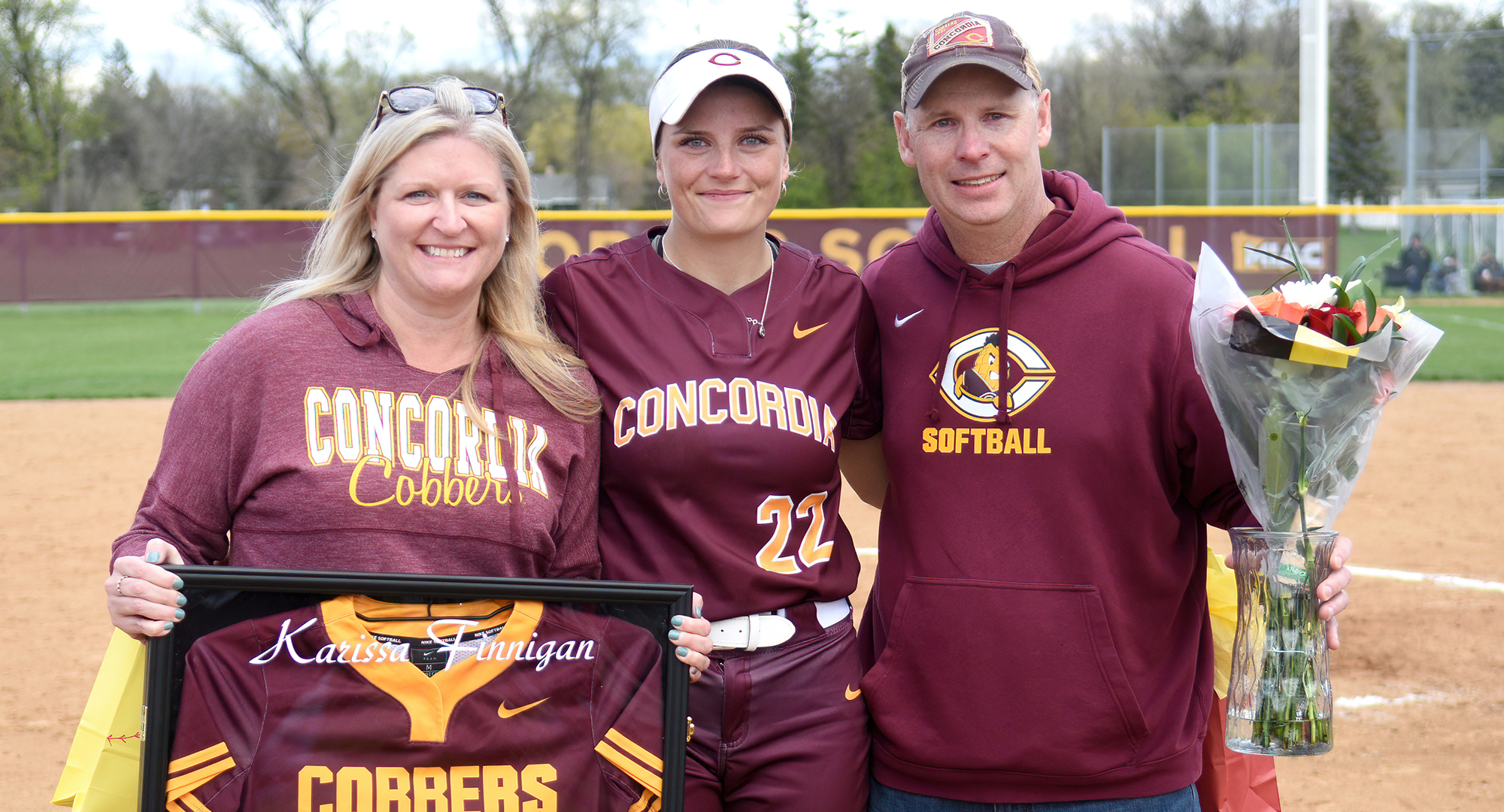 Senior Karissa Finnigan and her parents were honored in between games of the Cobbers' doubleheader against St. Olaf.