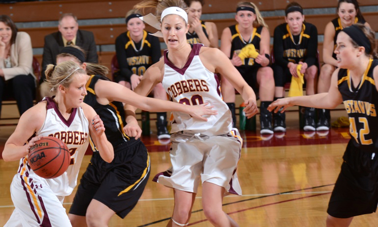 Alley Fisher (with ball) and Erin Januschka combined for 33 points in the Cobbers' 72-59 win over Gustavus.