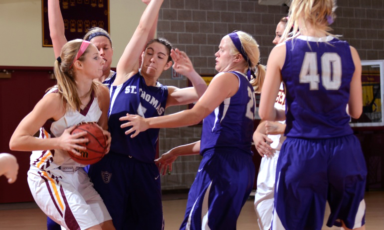 Erin Januschka finds it tough going against No.2 St. Thomas. Januschka was 4-for-6 from the field and had 10 points.