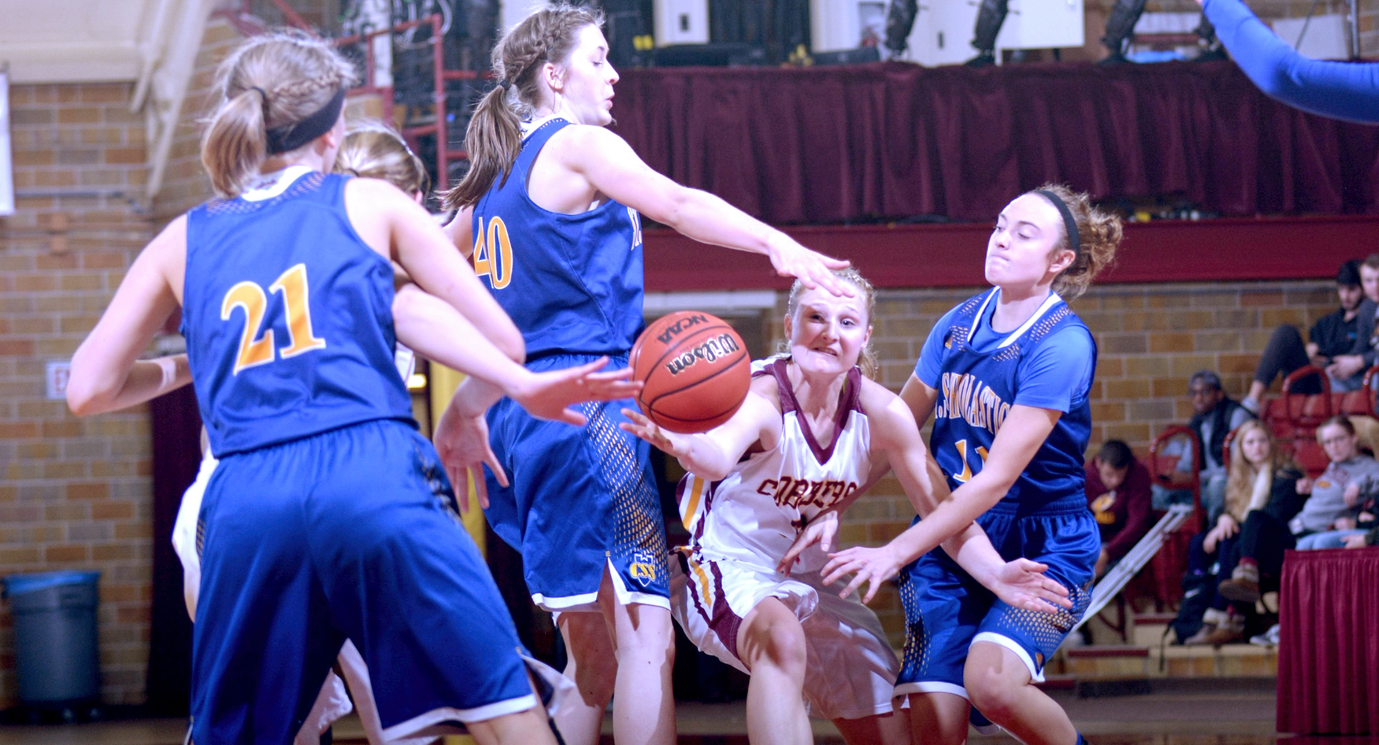 Senior Greta Walsh dishes the ball inside to one of the Cobber post players during the fourth quarter of Concordia's win against St. Scholastica.