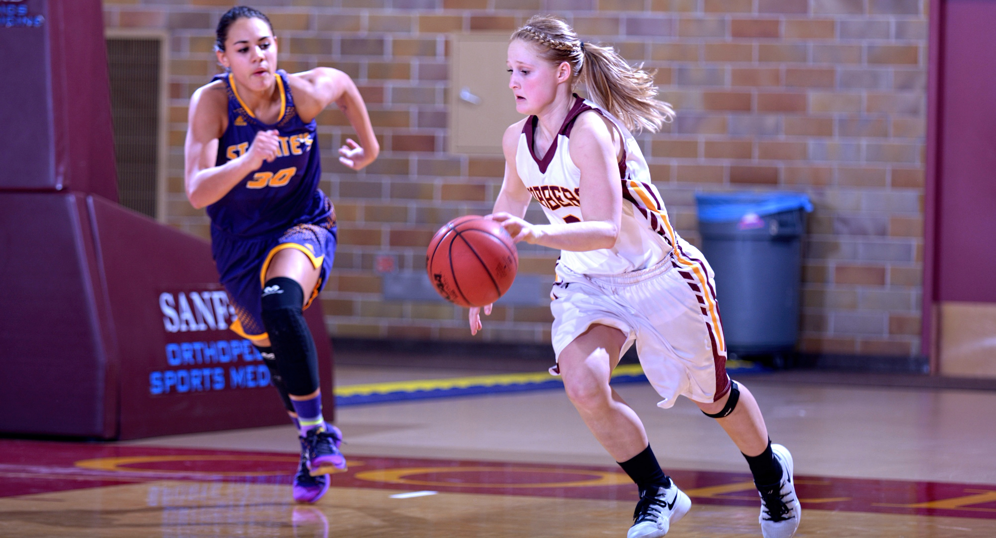 Senior Greta Walsh brings the ball up the court during the Cobbers' win over St. Catherine. Walsh had a career-high 28 points to lead all players.
