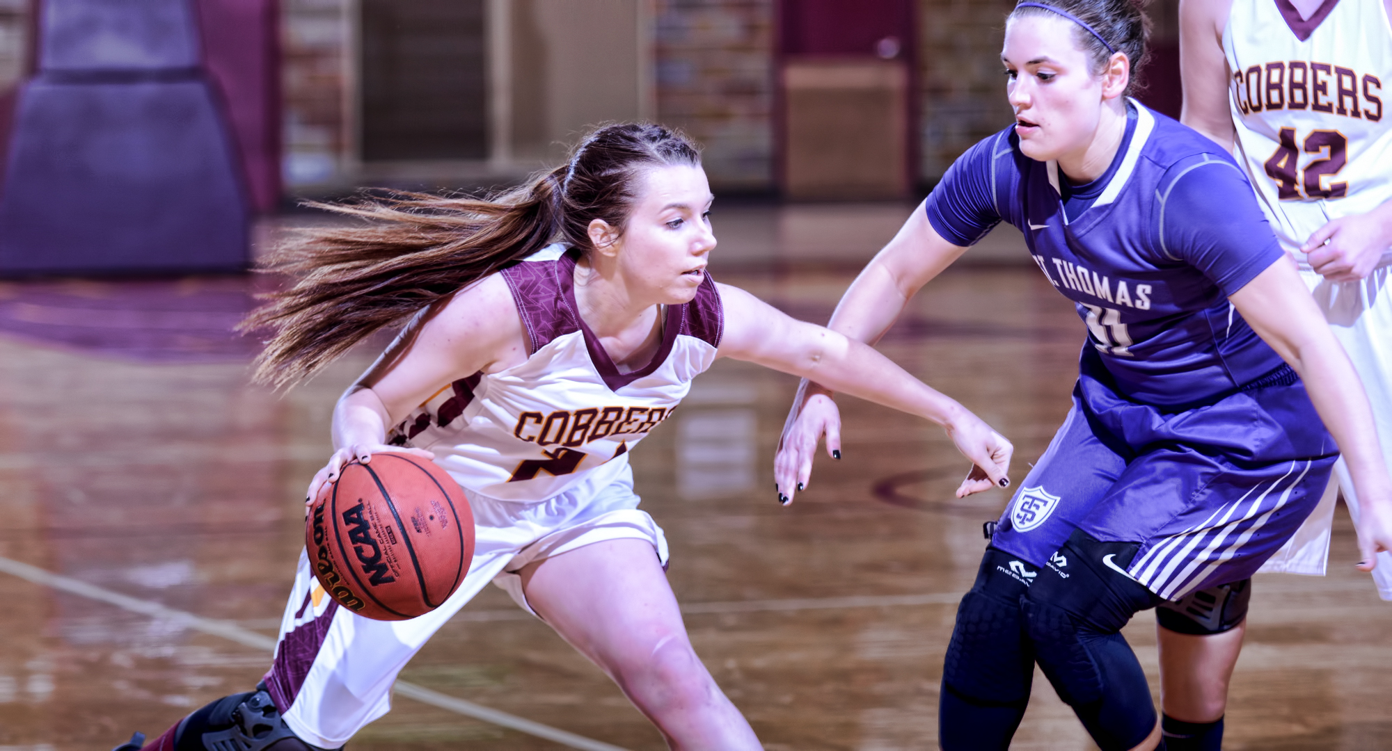 Senior Cassidy Rahman drives around a St. Thomas defender during the Cobbers' game with the nationally ranked Tommies. Rahman finished with five points and two assists. (Photo courtesy of Sam Sabin)