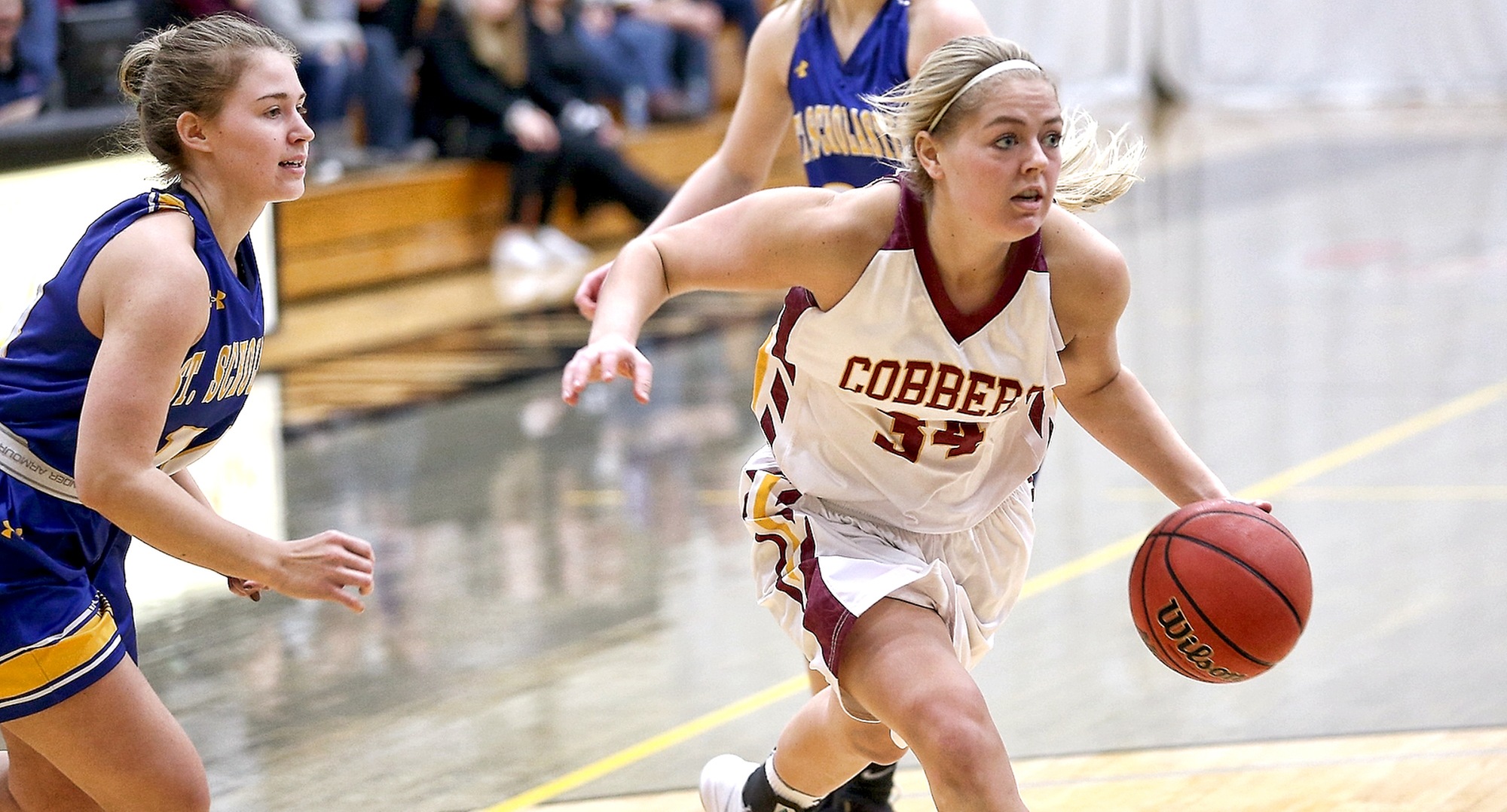 Grace Wolhowe drives to the basket for two of her team-high 20 points against St. Scholastica. (photo courtesy of Ryan Coleman, d3photography.com)