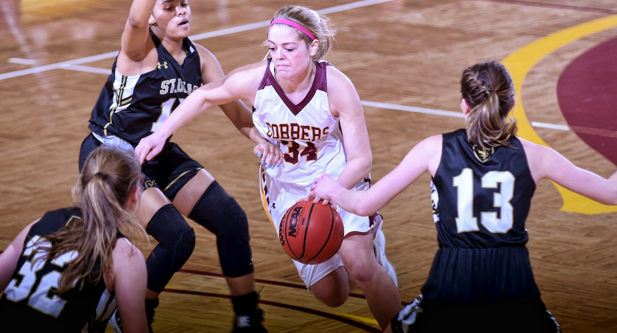 Senior Grace Wolhowe dribbles through traffic on her way to the basket in the second half of the Cobbers' game with St. Olaf. She finished with a team-high 16 points and a career-high six steals.