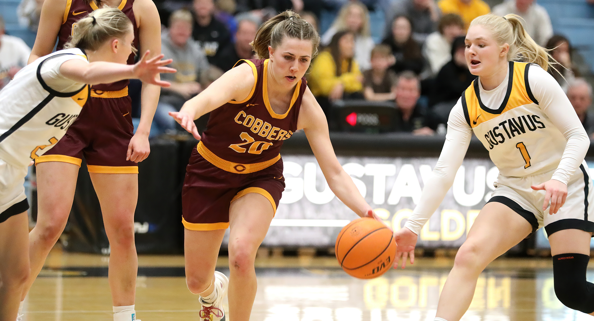 Emily Beseman dribbles through defenders during the Cobbers' game at Gustavus. (Photo courtesy of Piper Otto, Gustavus Sports Information)