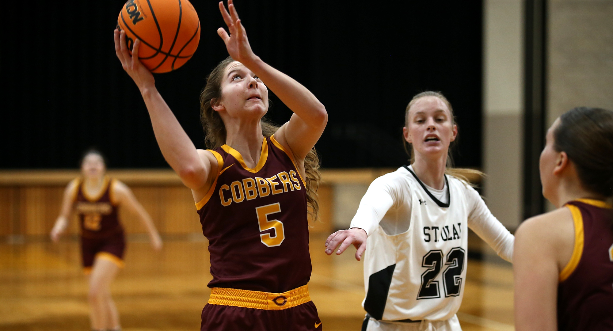 Genevieve Gruba lays in two of her season-high 11 points in the Cobbers' win at St. Olaf. (Photo courtesy of Ryan Coleman, D3photography.com)