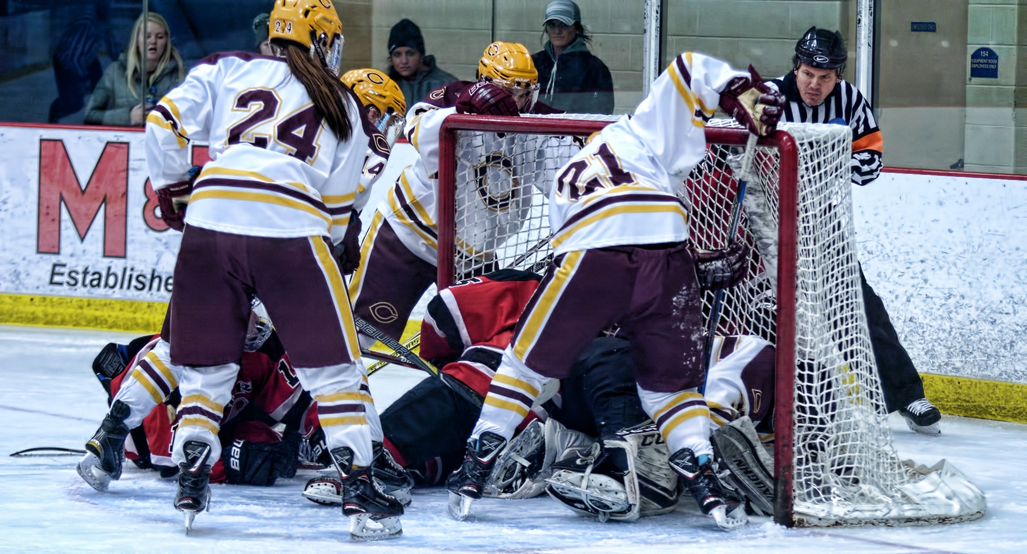 Players pile up in front of the Cobber goal, and netminder Amy Jost, during the third period of Concordia's contest with #6 Wis.-River Falls.