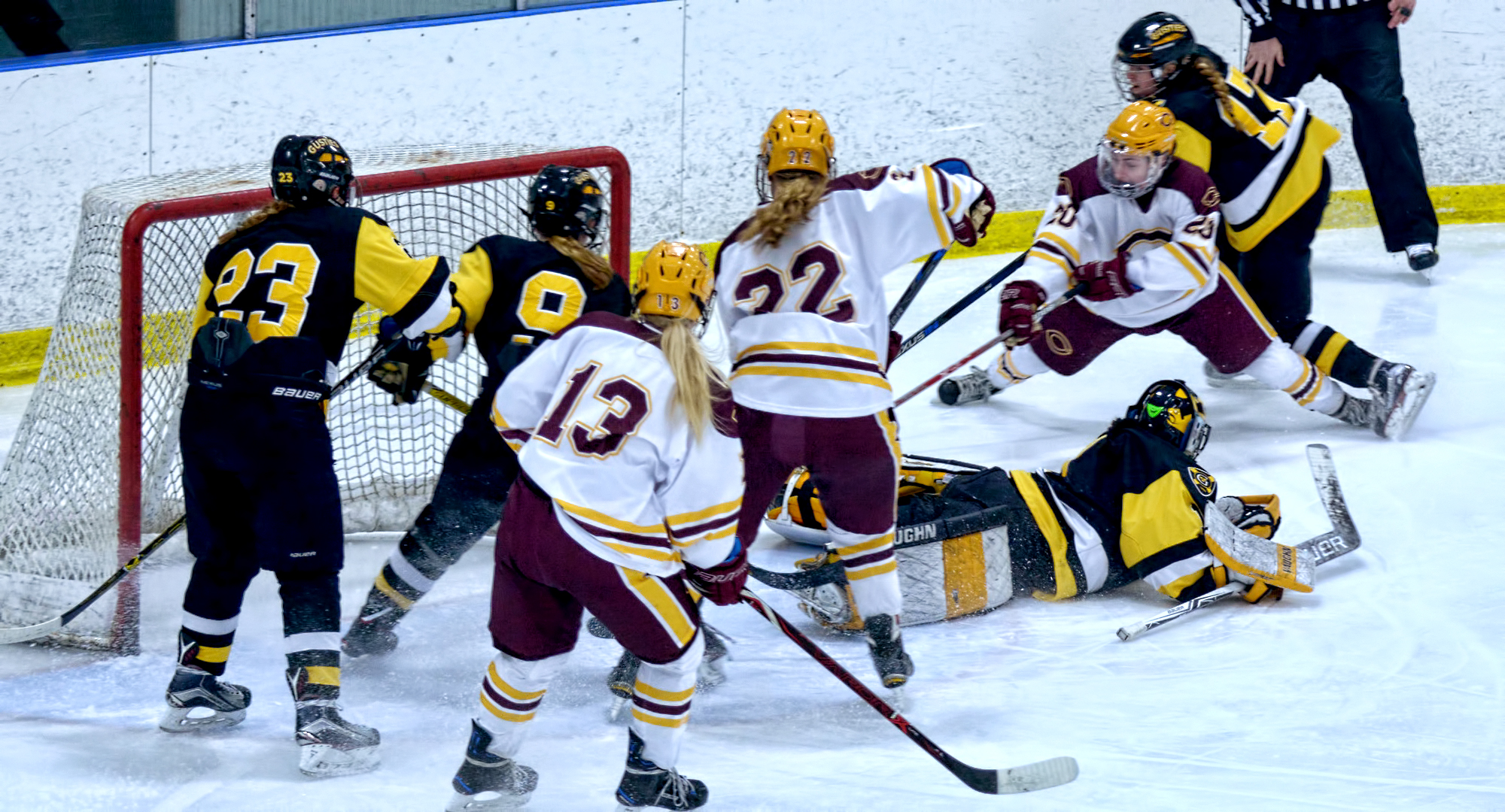 Maiah McCowan (#20) is forced around the Gustavus net before setting up the Cobbers' lone goal against the Gusties.