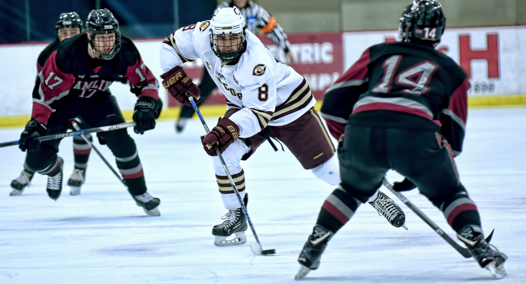 Junior Aaron Herdt brings the puck up the ice against Hamline in the Cobbers' 7-0 win. Herdt had a pair of goals and an assist to push his season total to 19 points.