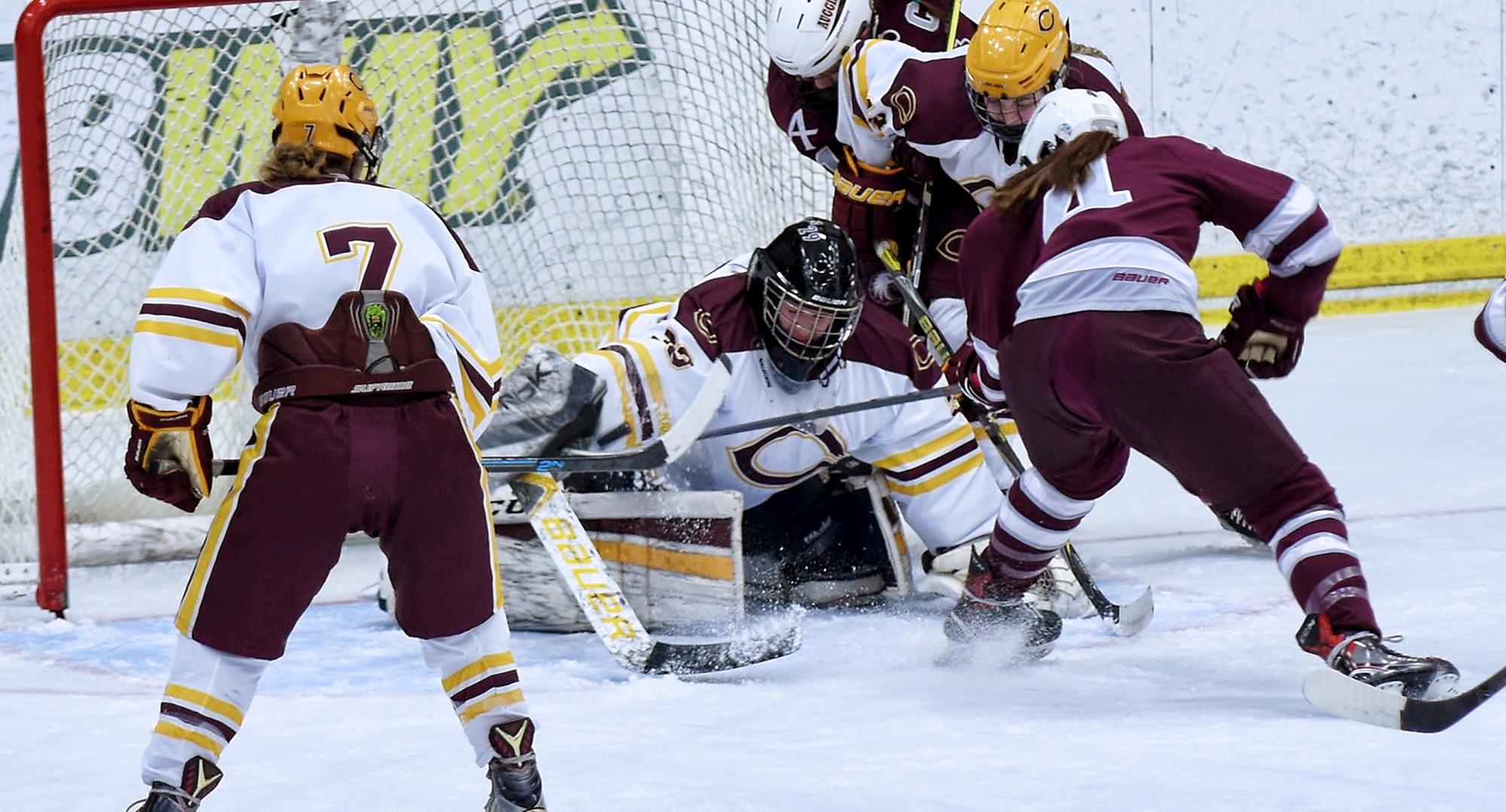 Goalie Emily Musielewicz covers the puck after one of her 32 saves in the Cobbers' series opener with Augsburg.