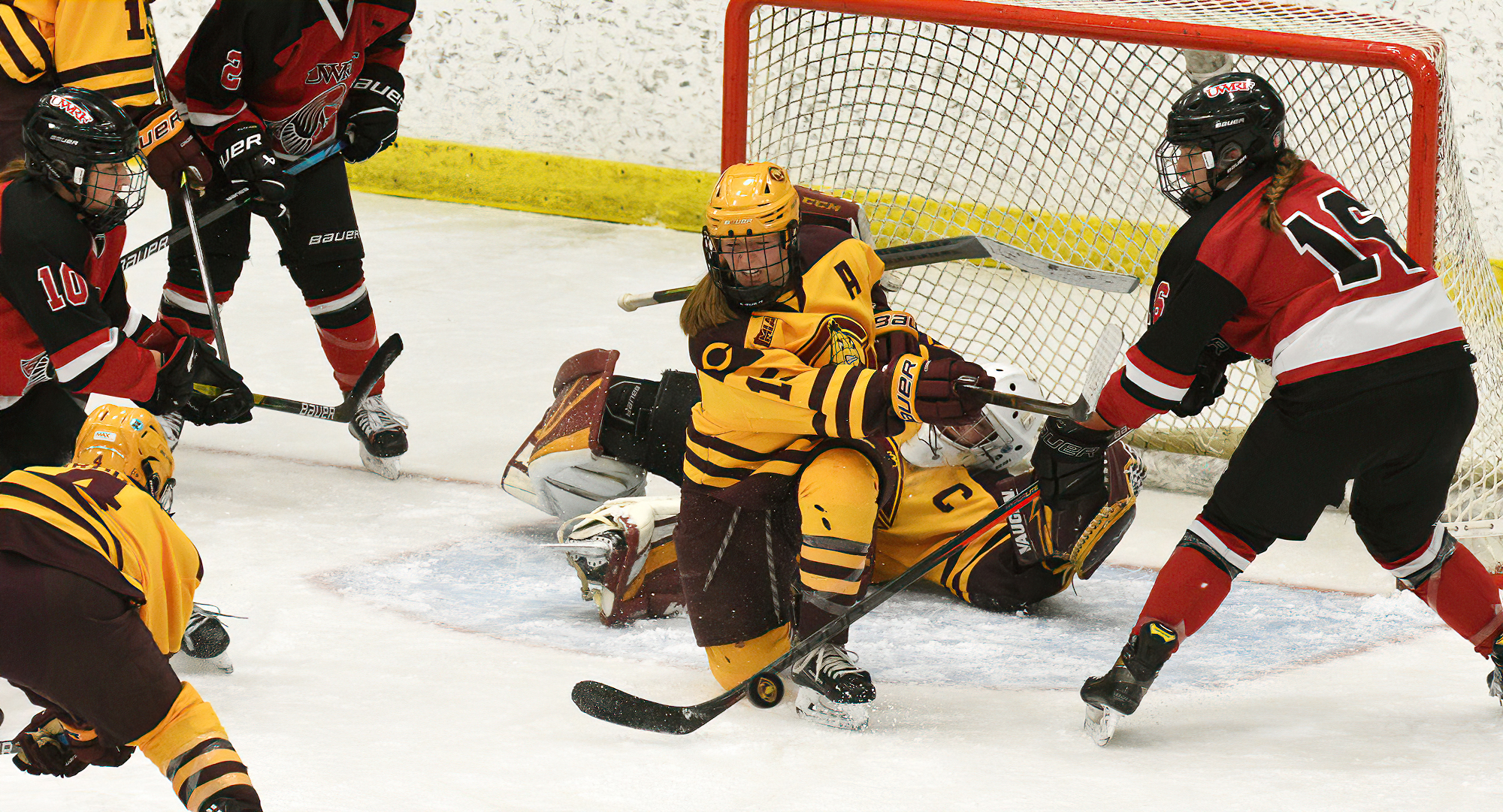 Junior Kaylie Klemetsrud clears the puck in front of the Cobber goal during the third period of their series opener with #2 Wis.-River Falls.