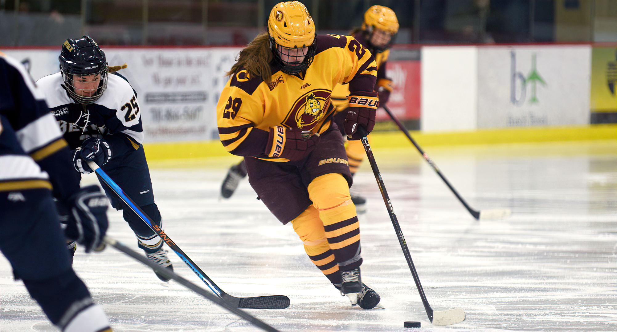 Jerica Friese carries the puck up the ice against Bethel. She  scored the game-winning goal in overtime in the Cobbers' 3-2 victory over Bethel.