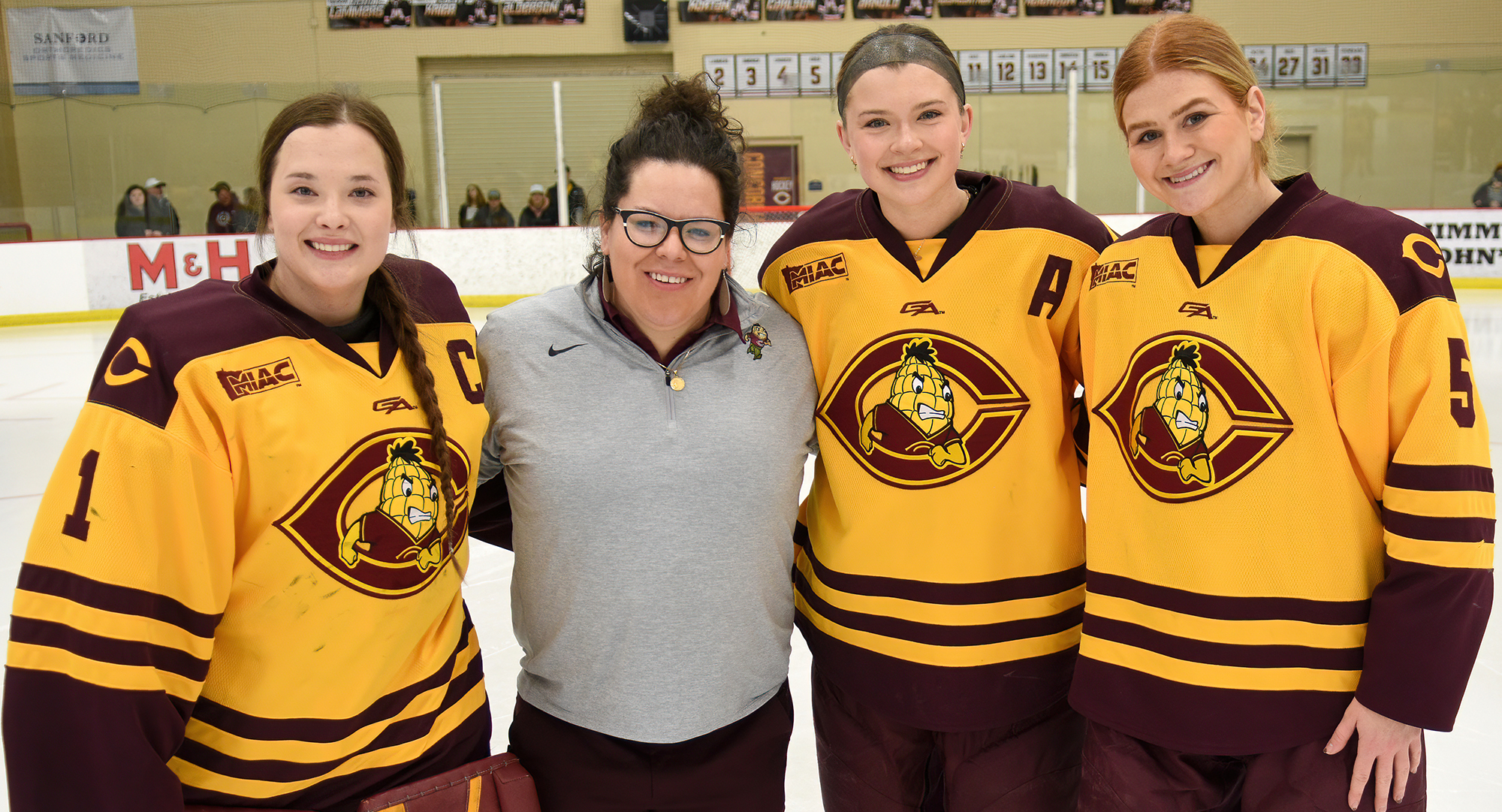 Concordia honored its three seniors (L-R: Kiana Flaig, head coach Mo Greiner, Grace Doerring, McKenzie Oelkers) before their game with St. Mary's.