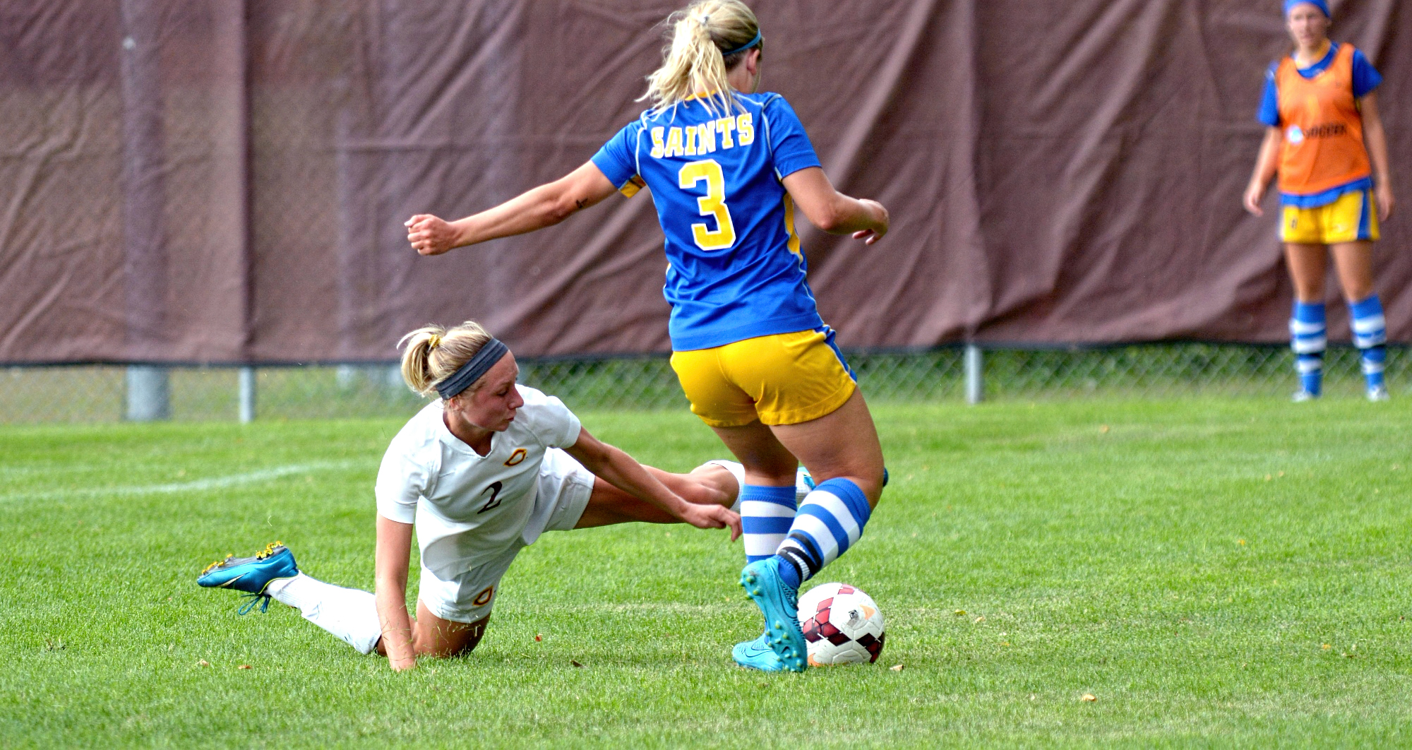 Sophomore central defender Katie Gillette sprawls on the ground to thwart a St. Scholastica offensive attack. She was named to the All-Tournament Team.