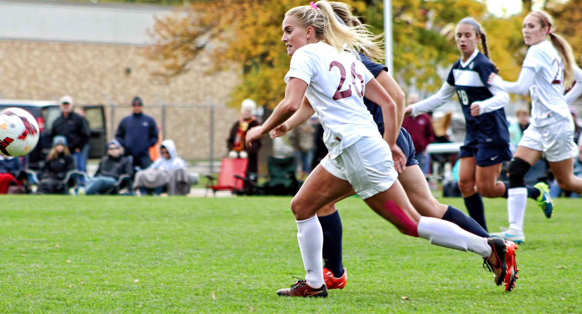 Senior forward Paige McCullough races a defender for the ball during the Cobbers' game with Carleton. McCullough scored CC's only goal in the game.