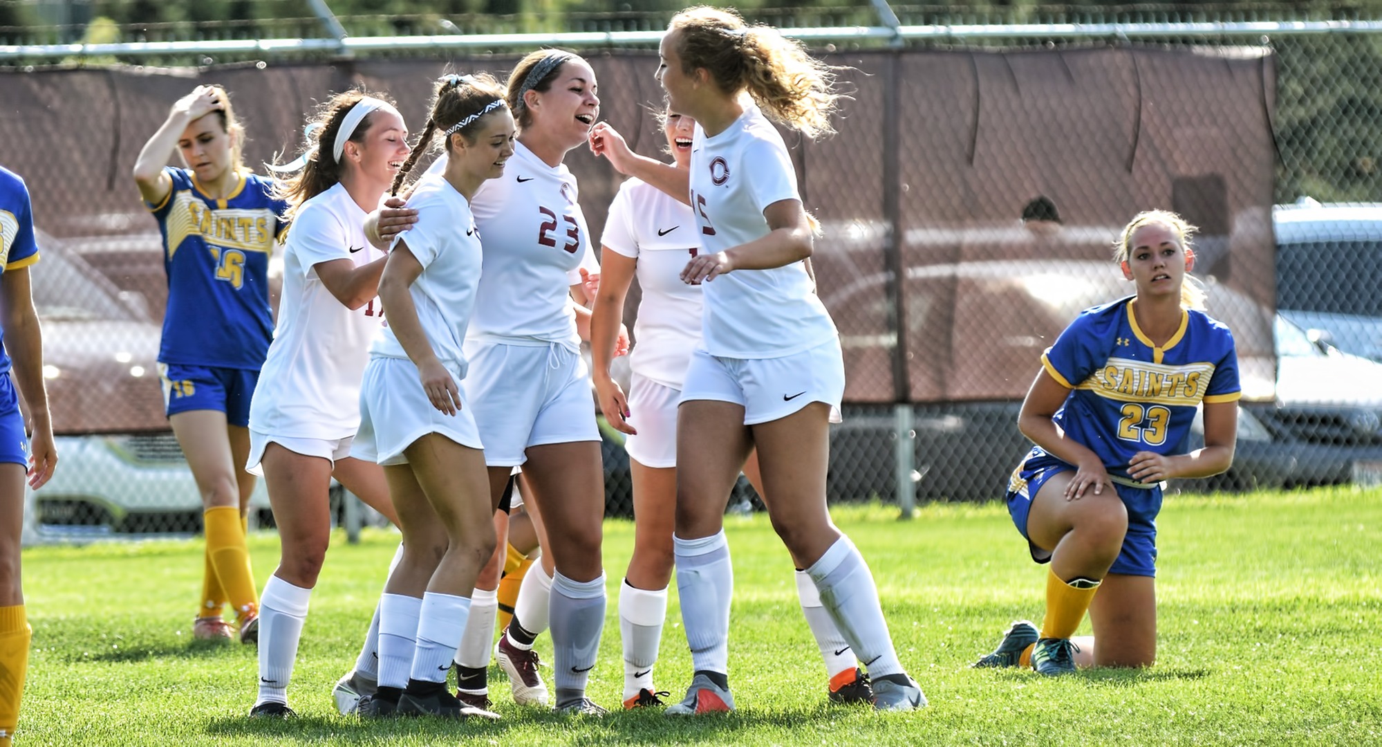 Teammates congratulate Kirsten Bokinskie after she scores one of her two goals in the Cobbers' 3-0 win vs. St. Scholastica.