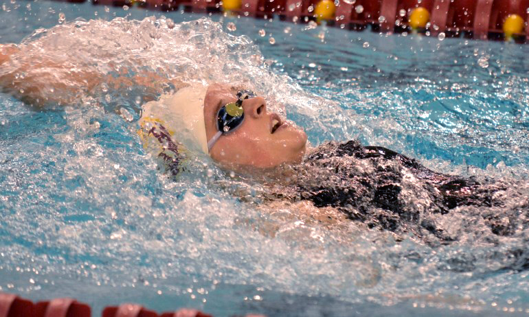 Sophomore Libby Hardwick races to a 12th-place finish in the 100-yard backstroke. (Photo courtesy of Matt Higgins)