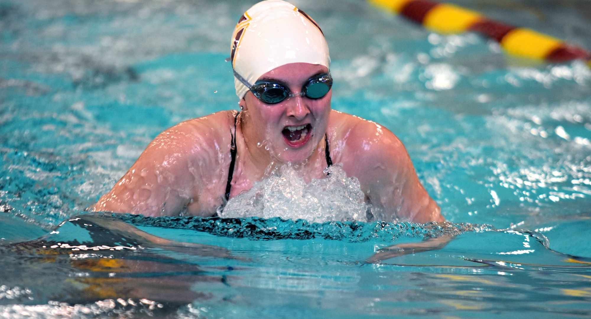 Sophomore Ciara White comes up for air in the 100-yard breaststroke in the Cobbers' dual with the Univ. of Mary. White won the event with the seventh fastest time in the MIAC this year.